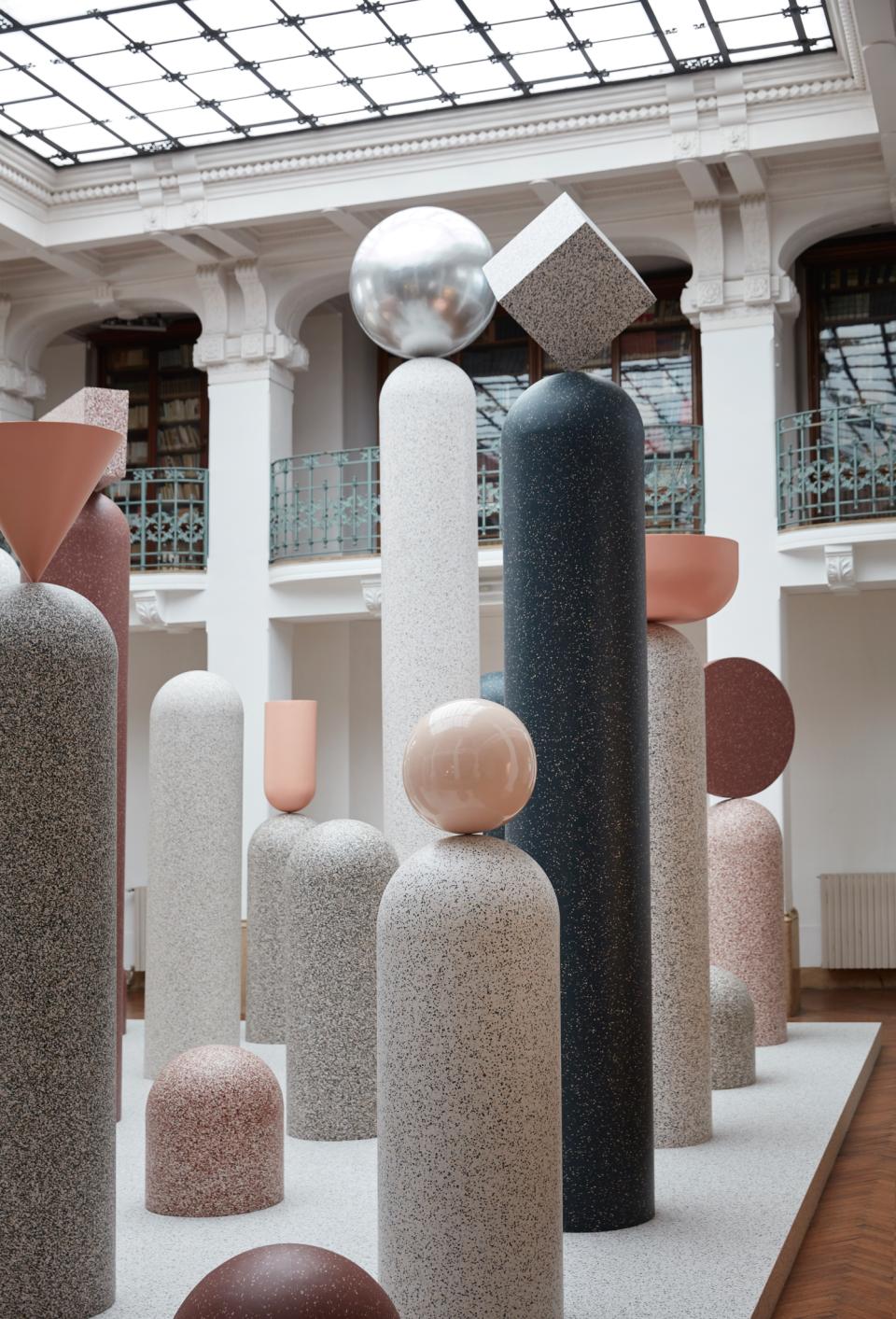 Colorful geometric sculptures and pillars displayed at Milan Design Week, showcasing Tarkett's innovative design collection.