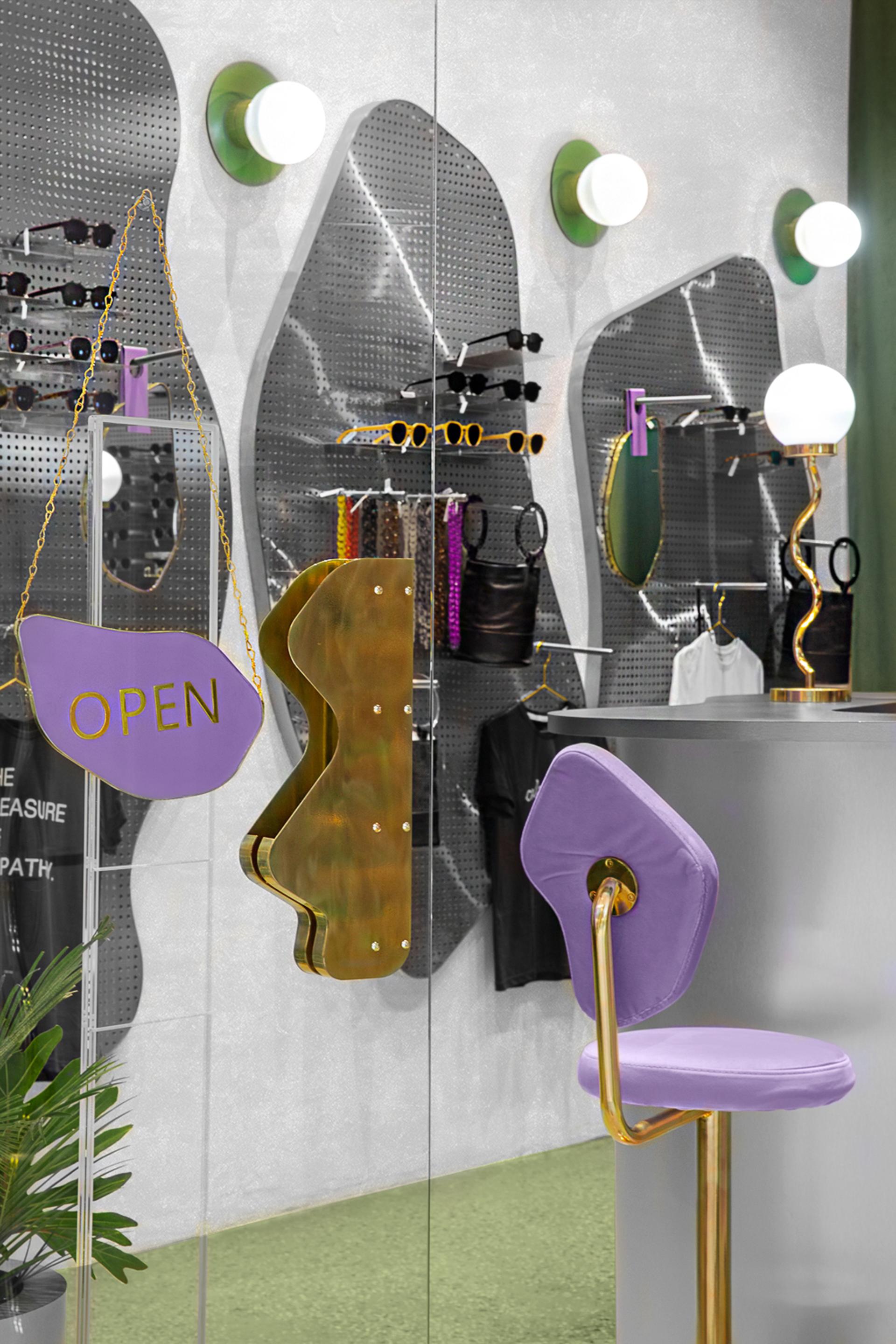 Stylish retail display featuring vibrant sunglasses and unique furniture in Breathe's new Colombia store.