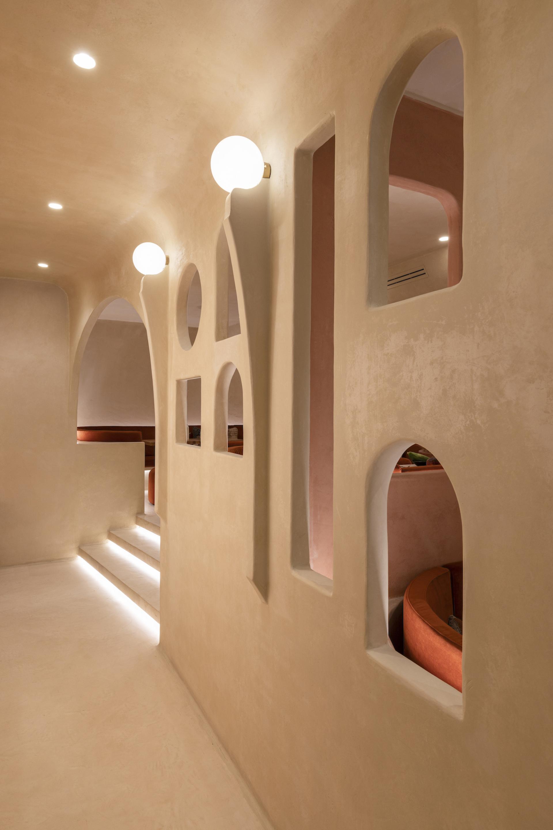 Interior view of Living Bakkali restaurant featuring Middle Eastern-inspired archways, soft lighting, and minimalist design elements.