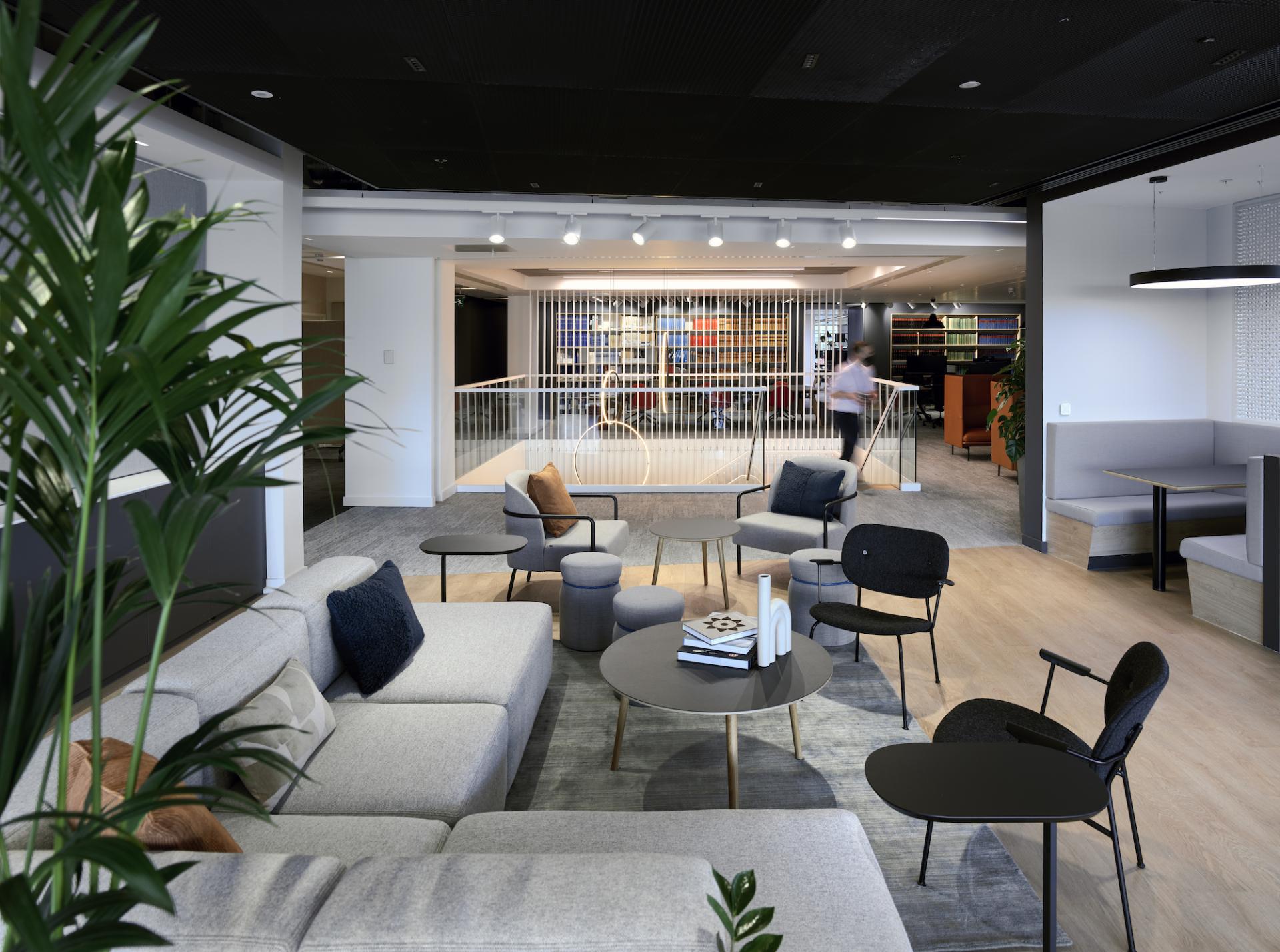 Modern open workspace design featuring stylish seating, natural light, and a collaborative atmosphere at Michael Laird Architects.