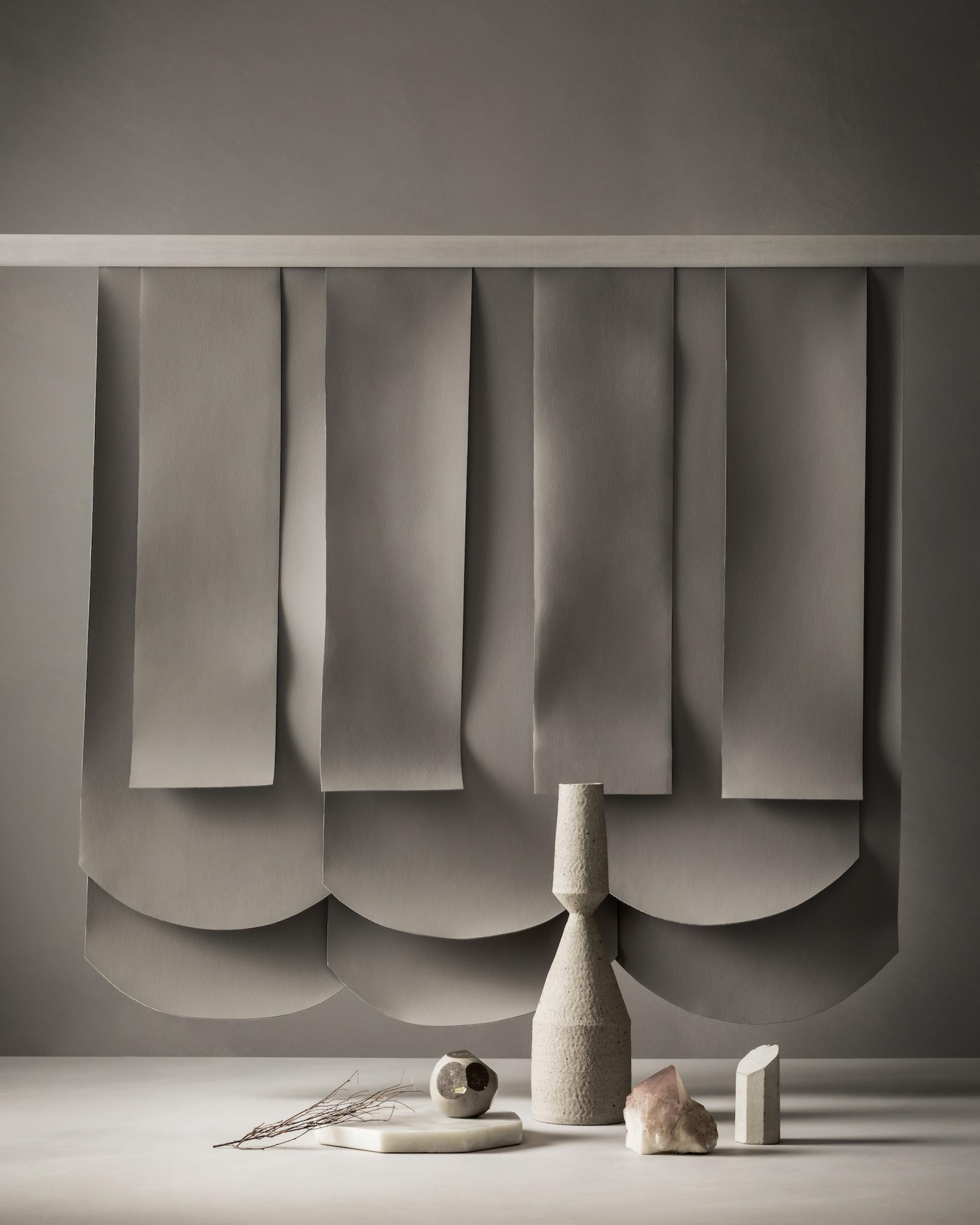 Earth-toned fabric samples arranged with minimalist decorative objects, showcasing Ultrafabrics' Volar Bio range's natural inspiration.