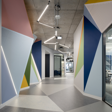 Vibrant, geometric hallway design at Autodesk's Dublin headquarters featuring colorful walls and modern lighting.