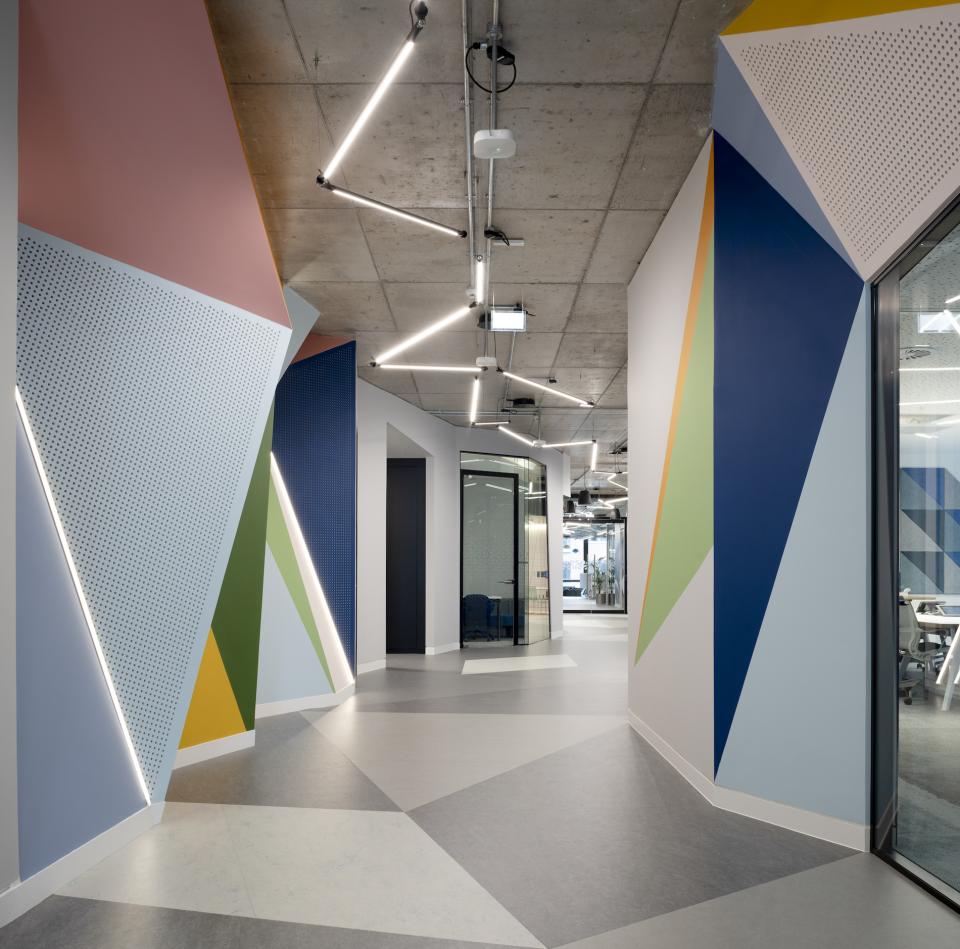 Vibrant, geometric hallway design at Autodesk's Dublin headquarters featuring colorful walls and modern lighting.