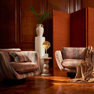 Stylish living room featuring Art Deco-inspired furniture with bold floral patterns, warm colors, and decorative accents.