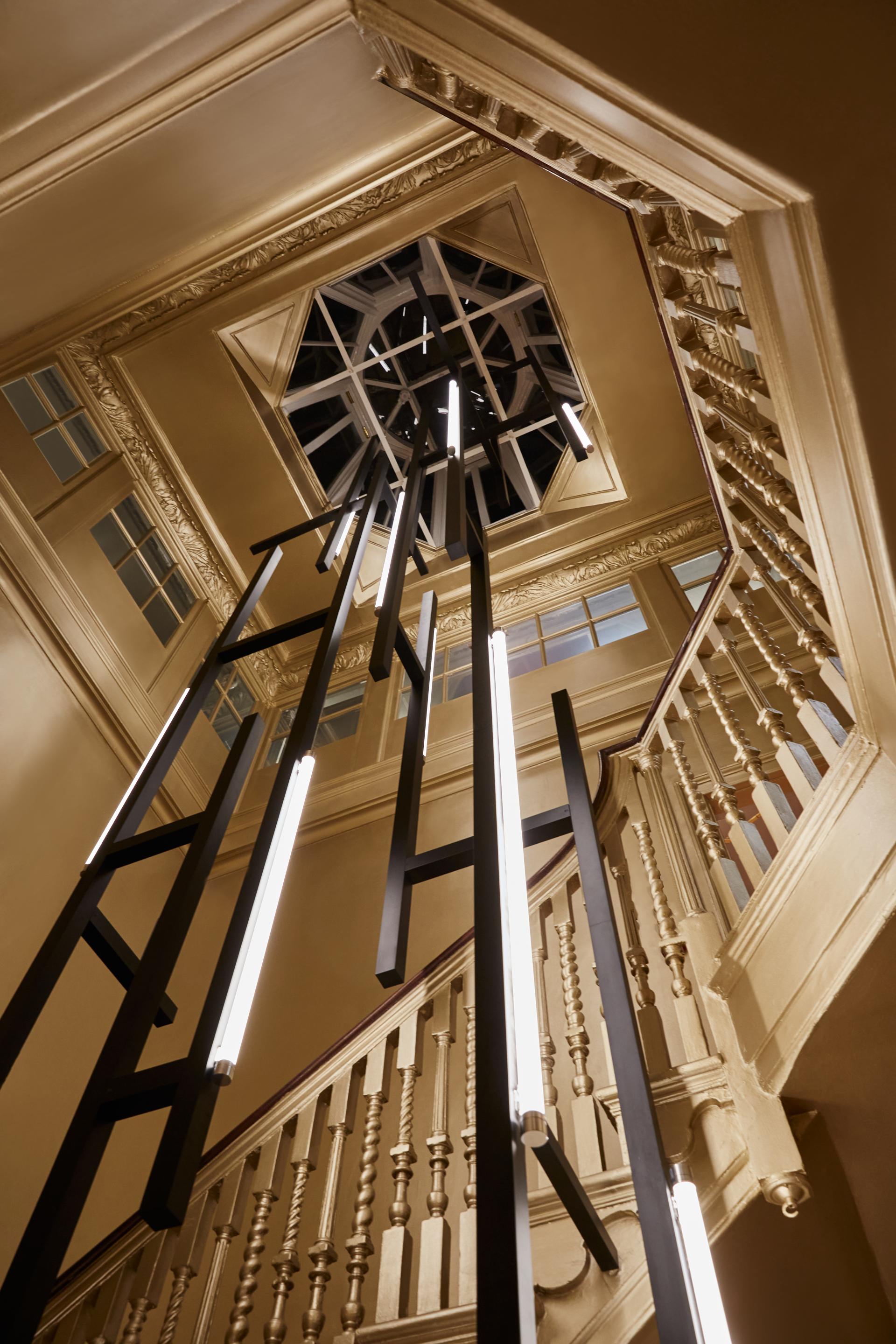 Elegant staircase featuring striking modern lighting design by Nulty in luxury retail environment at Browns, London.