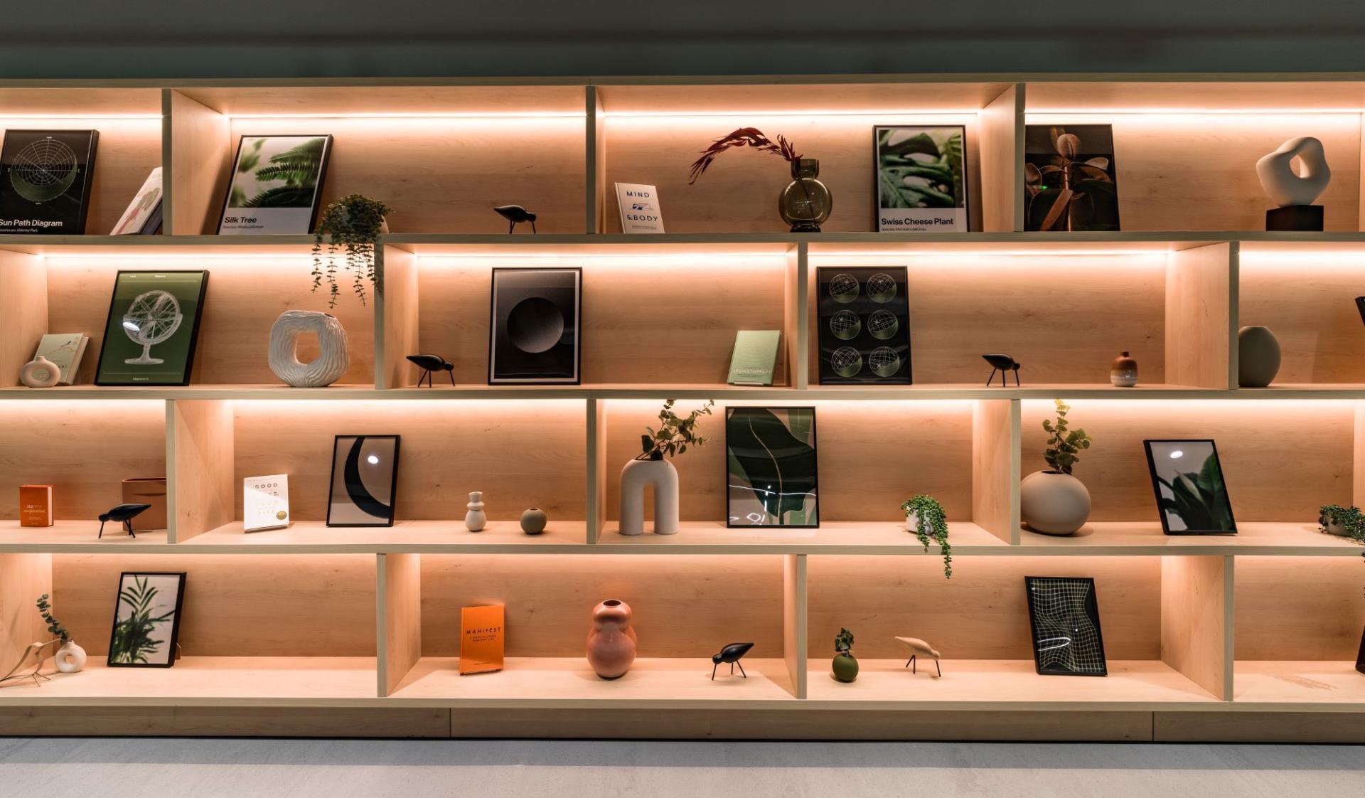 Stylish display shelf featuring plants, art, and decor in the new Nest concept at Alderley Park's Glasshouse.