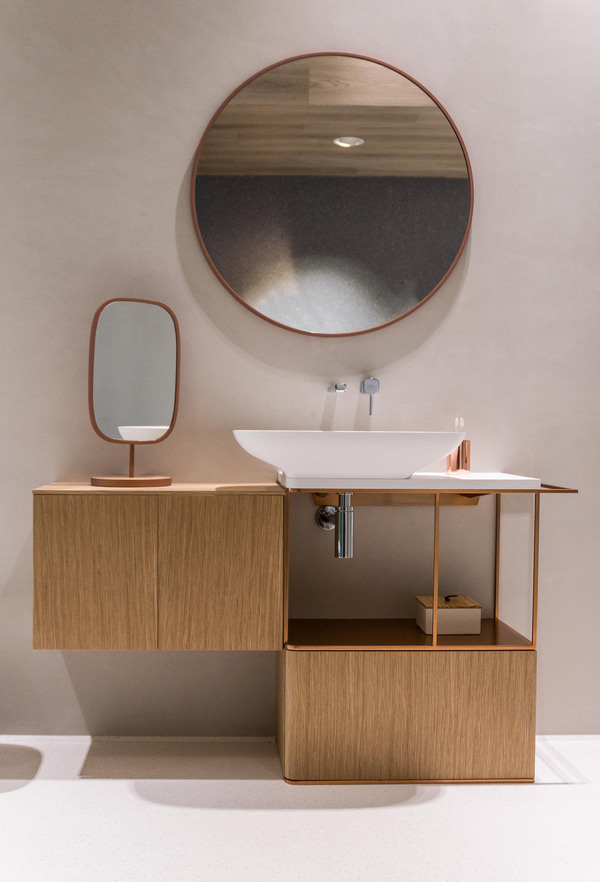 Stylish bathroom vanity featuring earthy clay tones, a round mirror, and sleek design elements ideal for autumn decor.