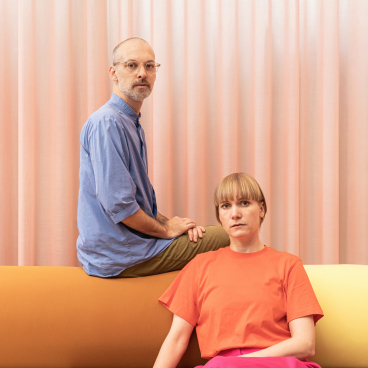 Christoph Brach and Daniera ter Haar pose on a color-blocked sofa, discussing bio-based color palettes and future materials.