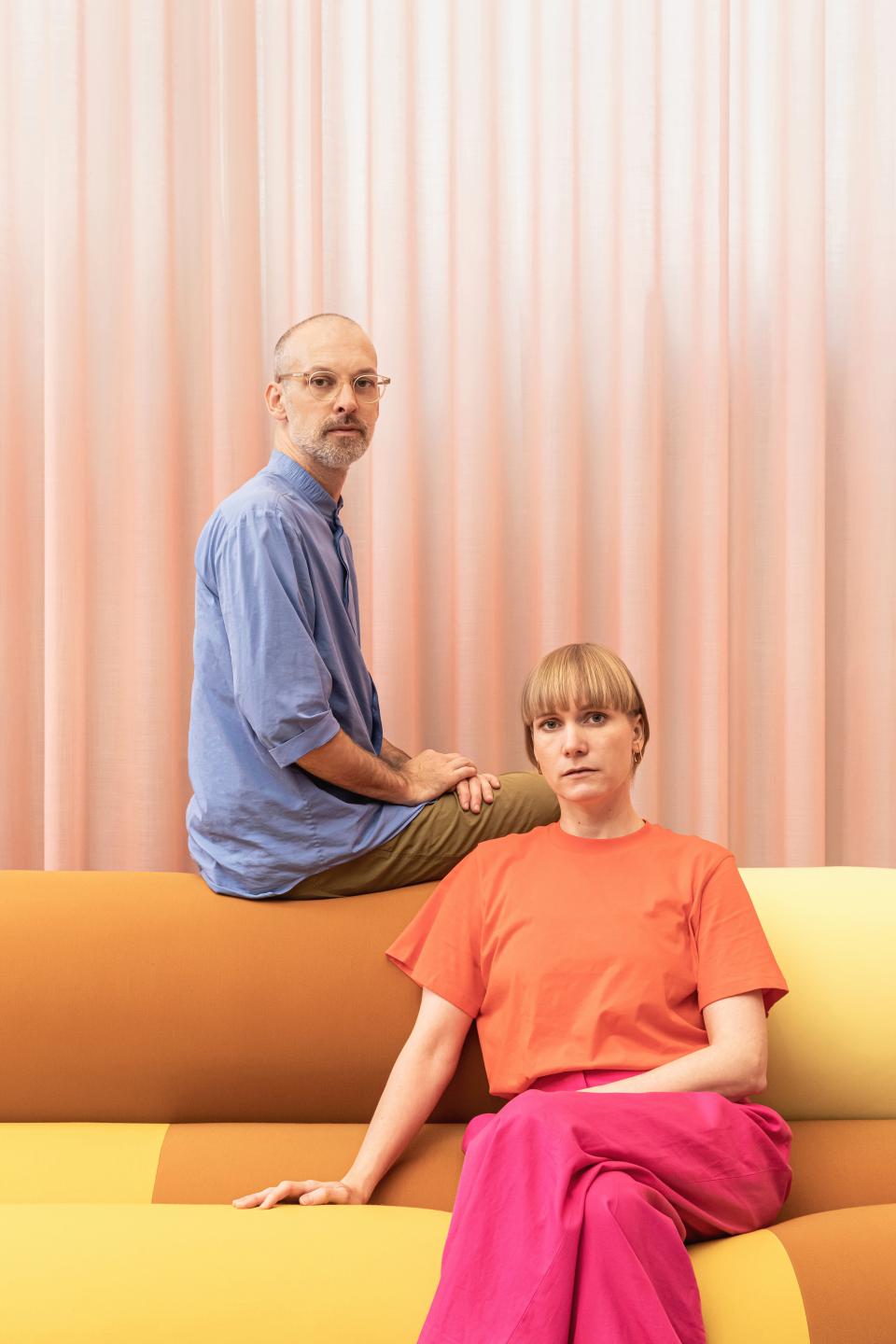 Christoph Brach and Daniera ter Haar pose on a color-blocked sofa, discussing bio-based color palettes and future materials.