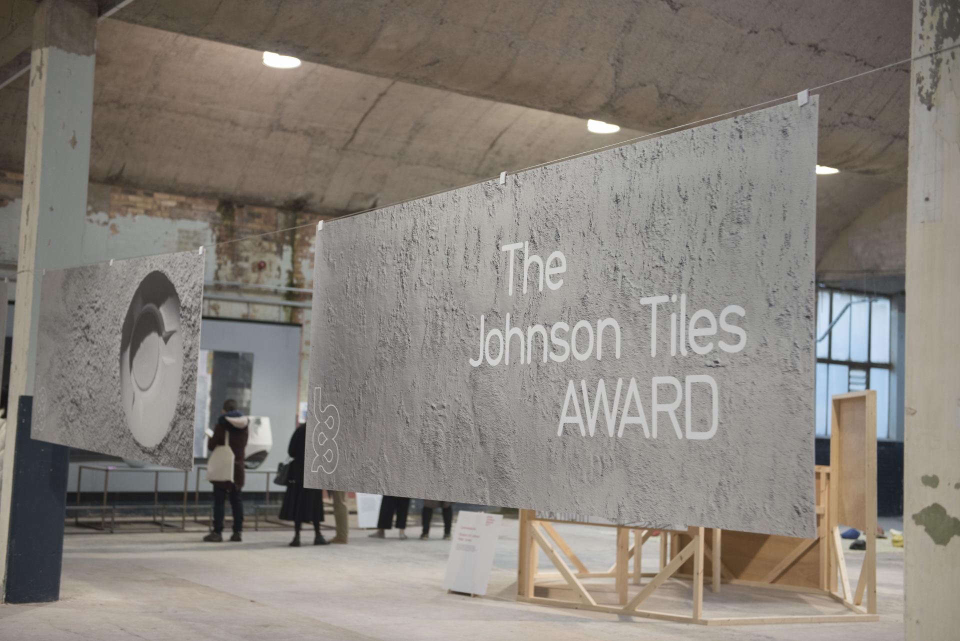 Exhibition space showcasing Tana West's (UN)WOVEN installation, featuring Johnson Tiles Award signage and viewers engaging with the artwork.