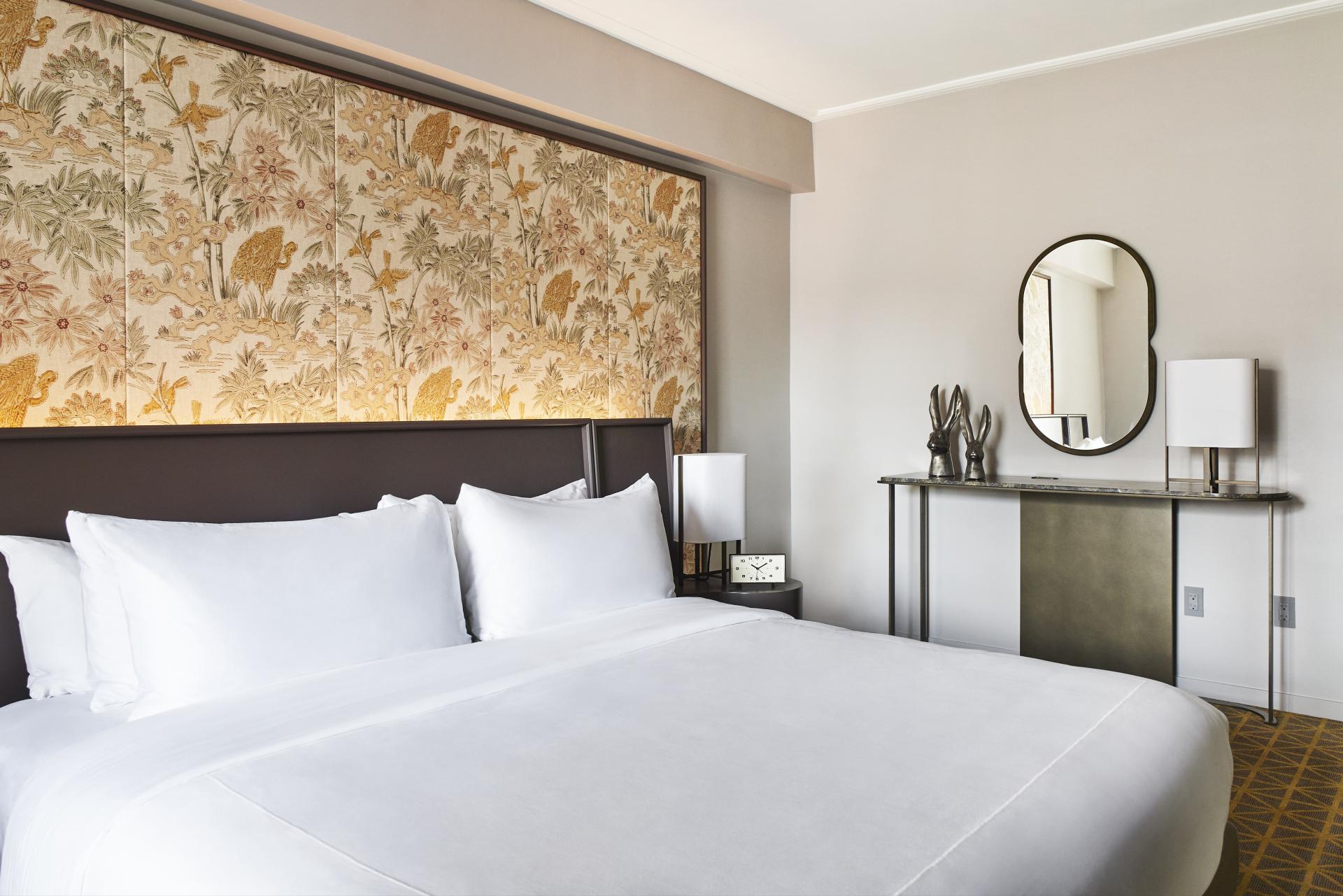 Luxurious hotel room at Park Lane New York, showcasing elegant decor and a stylish headboard with floral patterns.