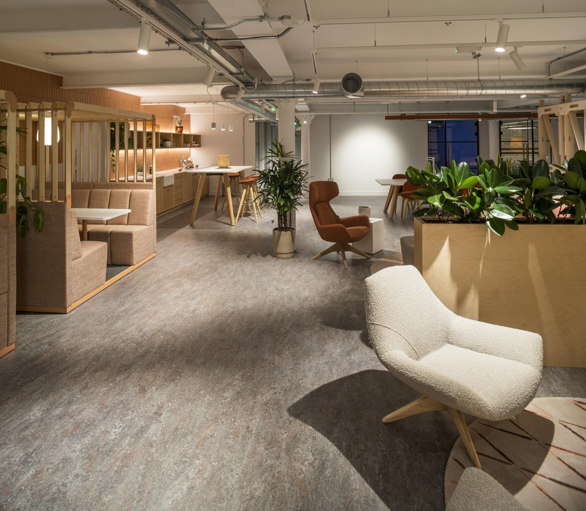 Modern interior of Material Source Studio in Manchester, featuring stylish seating, greenery, and a welcoming workspace atmosphere.