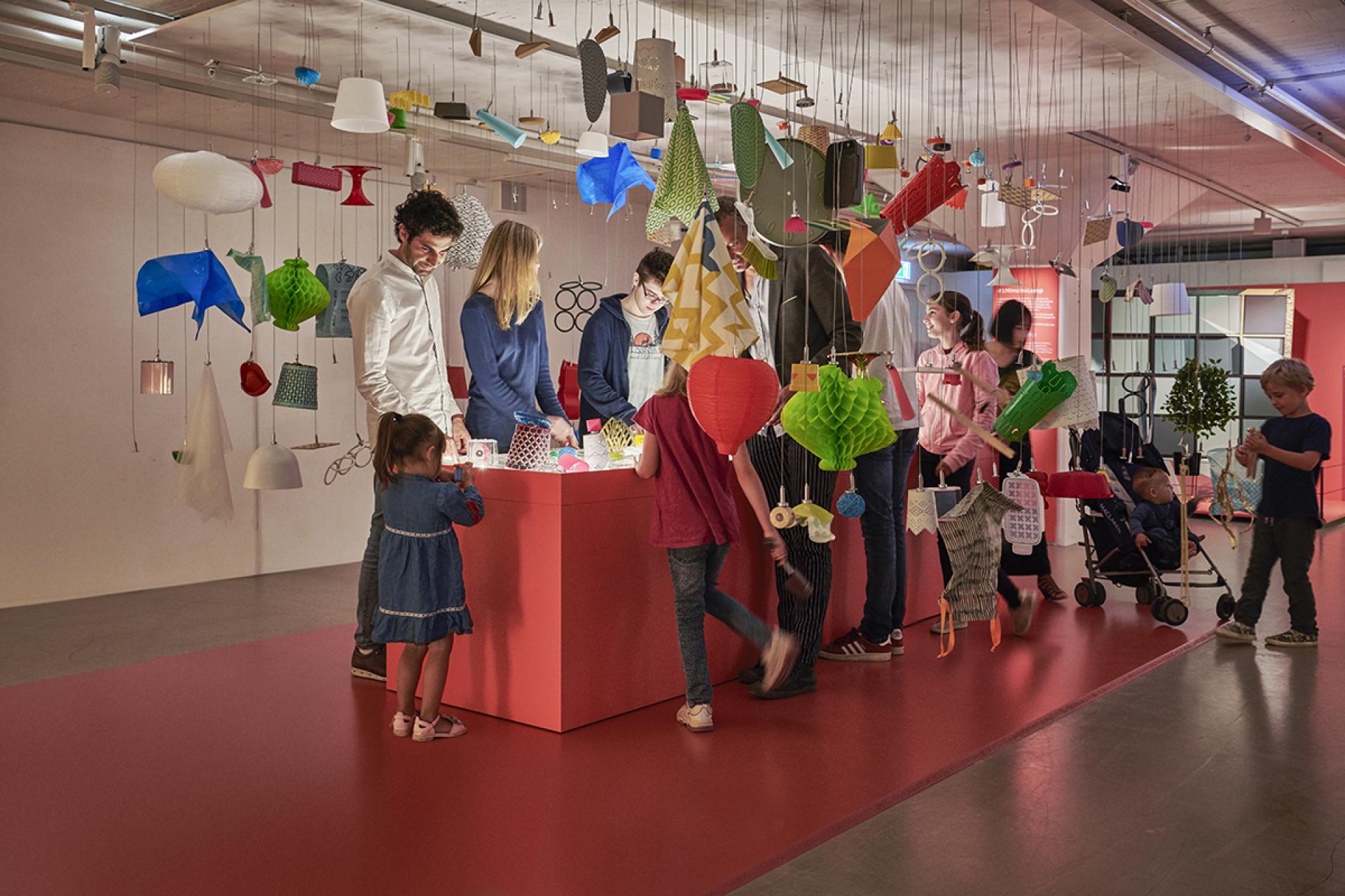 Interactive exhibit at the IKEA Museum showcasing colorful decorative elements, engaging visitors of all ages in a vibrant atmosphere.
