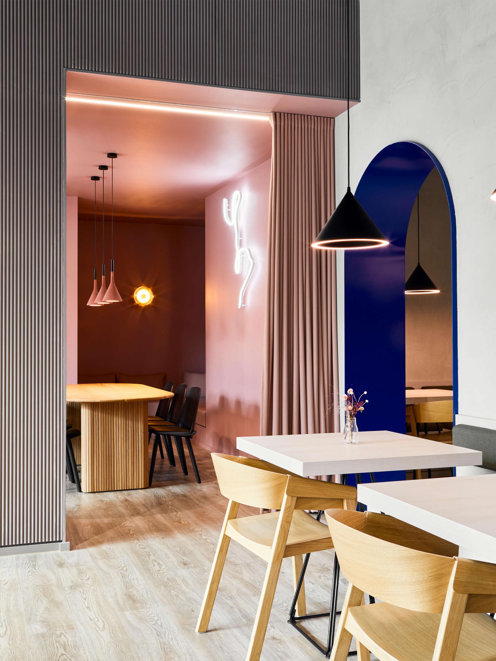 Contemporary interior design featuring a vibrant color palette, stylish furniture, and creative lighting elements at NoChintz studio.