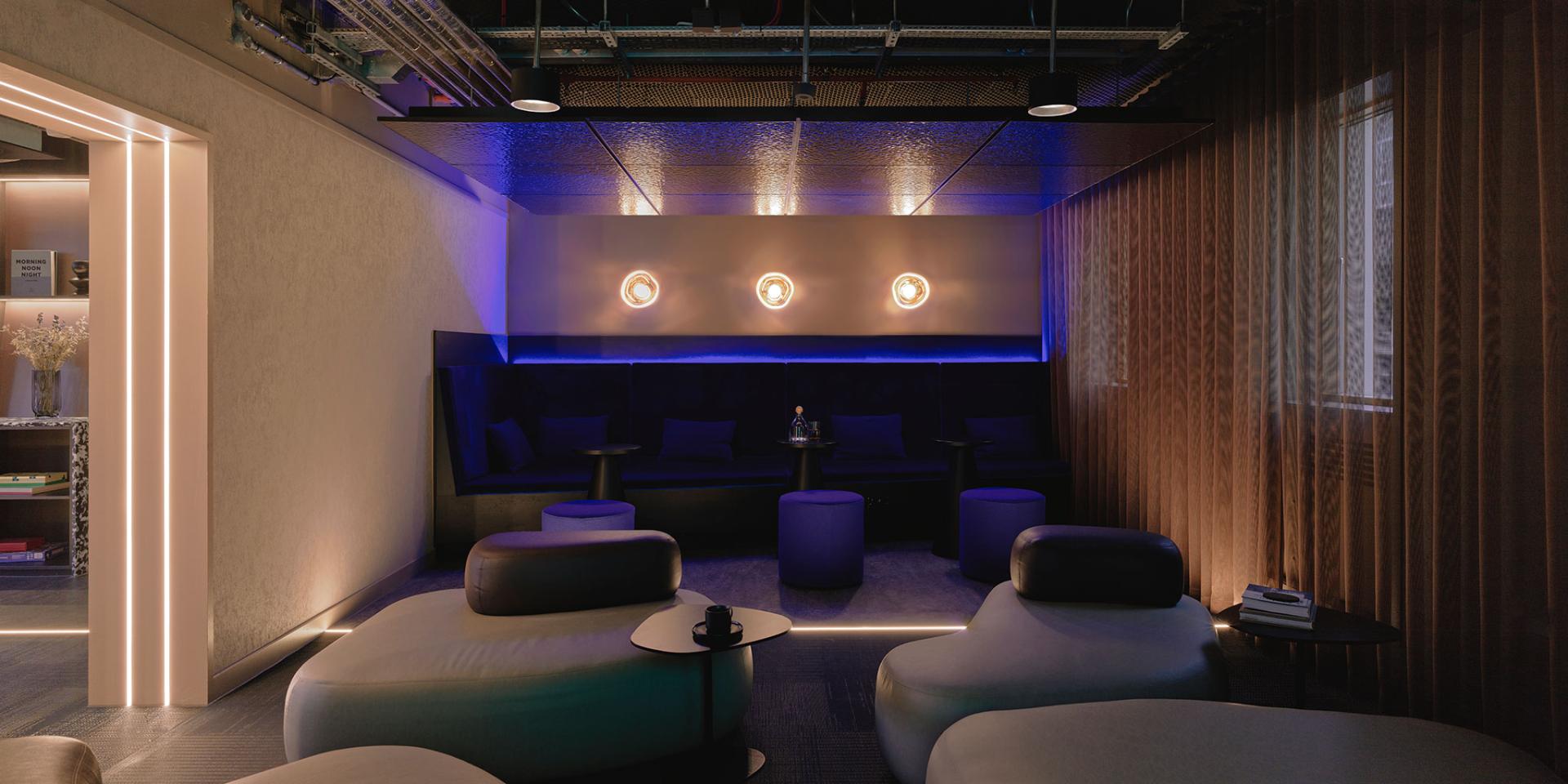 Chic interior lounge space at 16-18 Potterrow, Edinburgh, featuring modern seating and atmospheric lighting design.