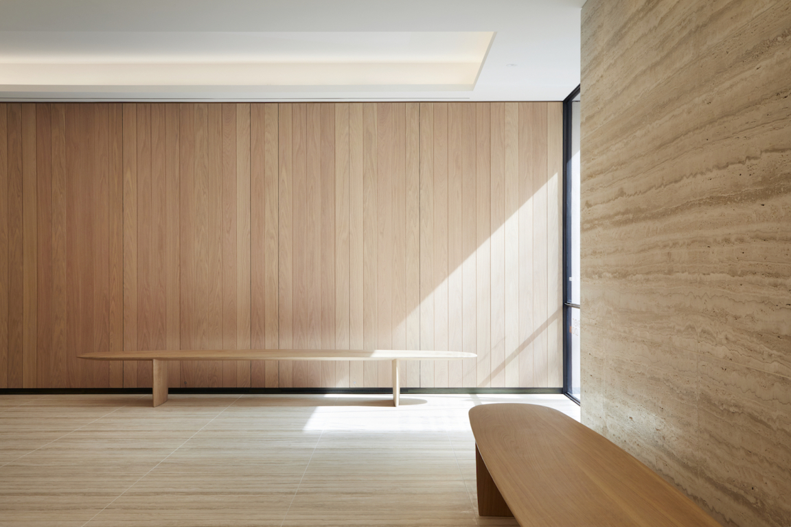 Elegant interior featuring wooden paneling and sleek furniture by Benchmark, highlighting craftsmanship in British design.