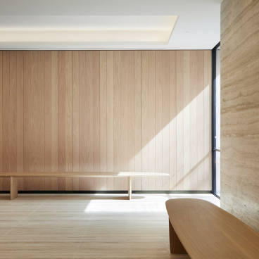 Elegant interior featuring wooden paneling and sleek furniture by Benchmark, highlighting craftsmanship in British design.
