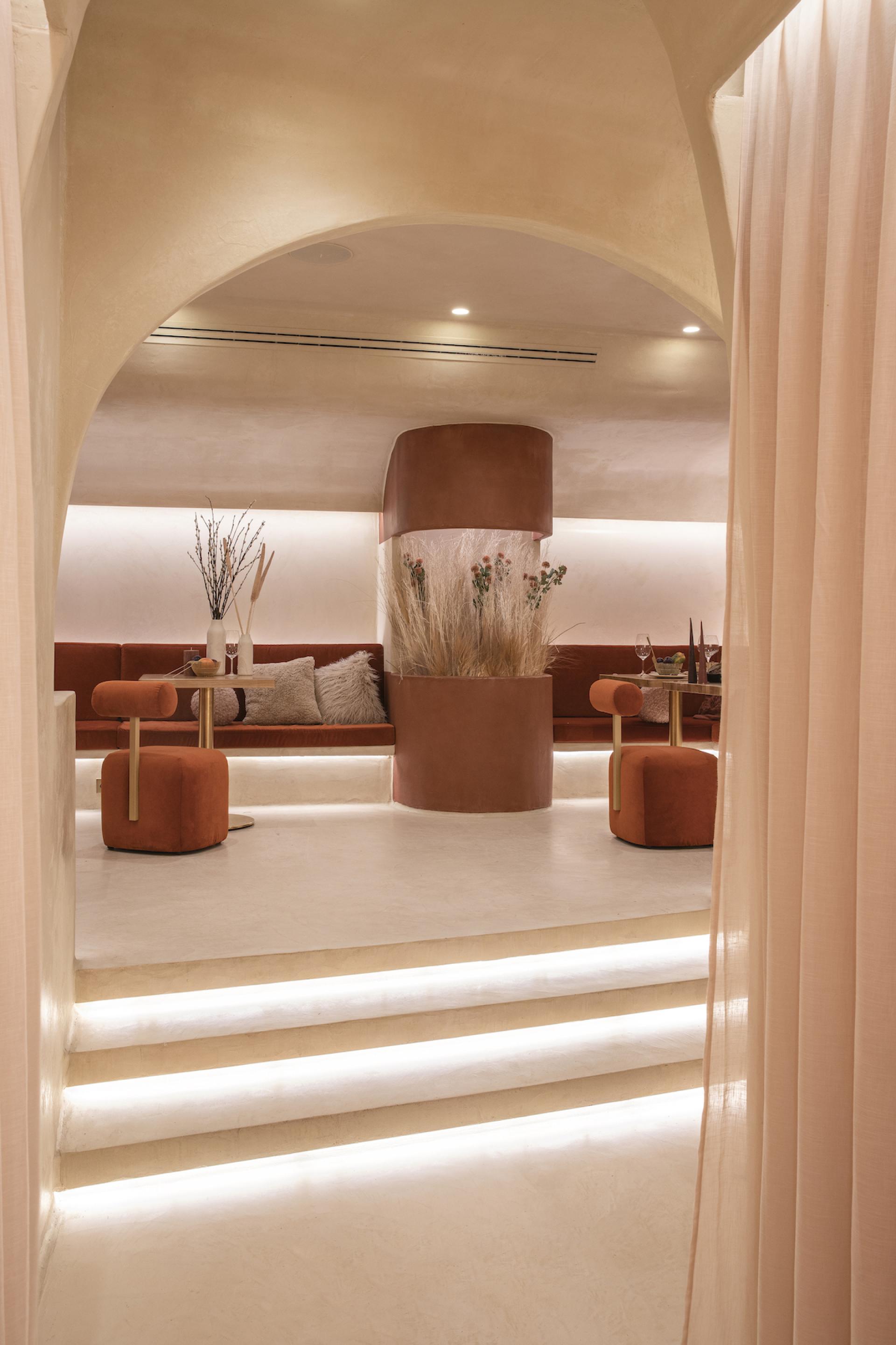 Contemporary dining area in Living Bakkali restaurant, featuring Middle Eastern-inspired decor and warm, inviting colors.