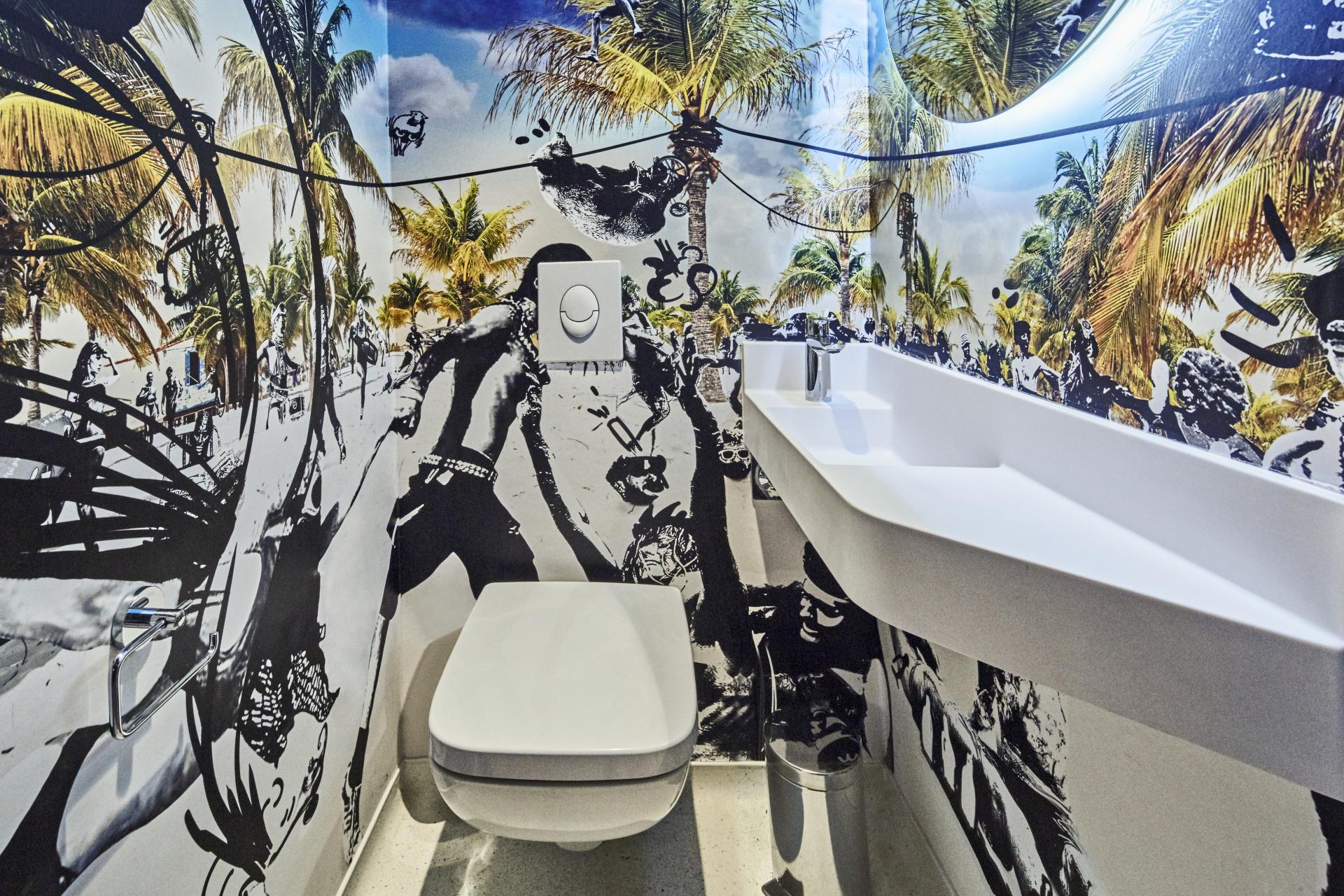 Vibrant restroom interior at JO&JOE Paris Gentilly showcasing creative wall art and modern design elements.