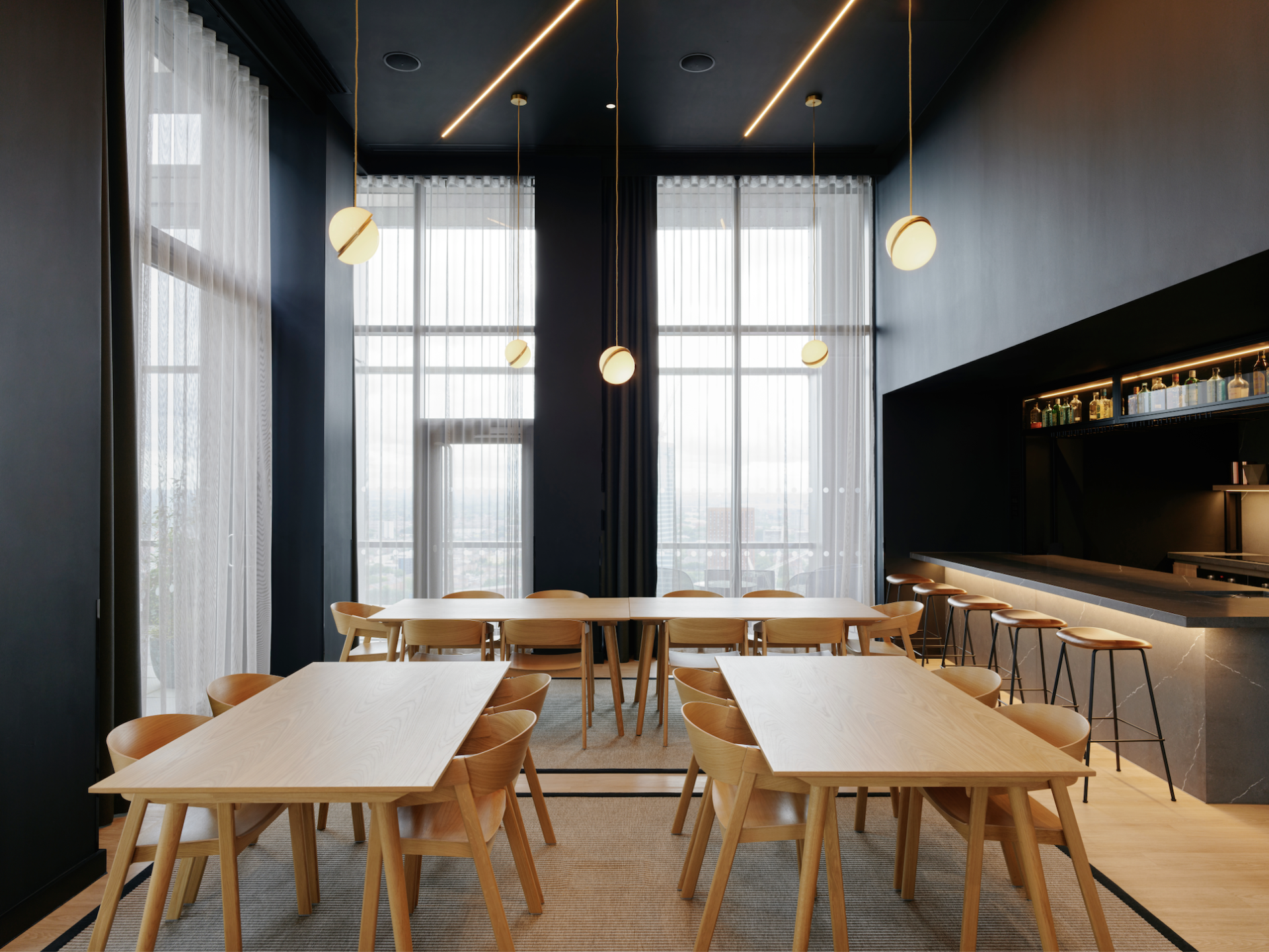 Modern dining area with stylish wooden furniture and large windows, showcasing the elevated lifestyle of Vita Group's uhaus brand.