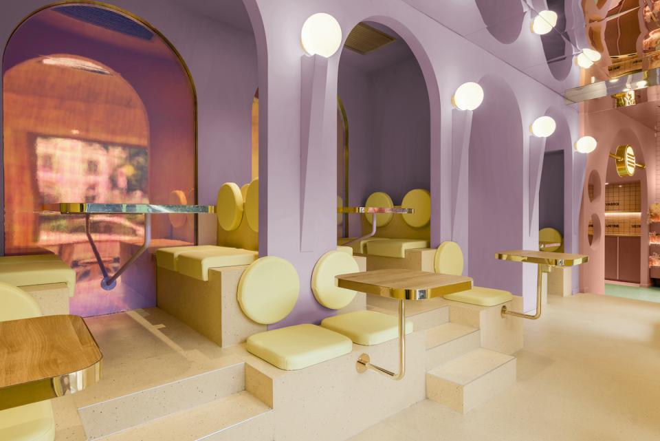 Colorful interior design of Masquespacio's Bun restaurant in Milan, featuring unique seating and modern decor elements.