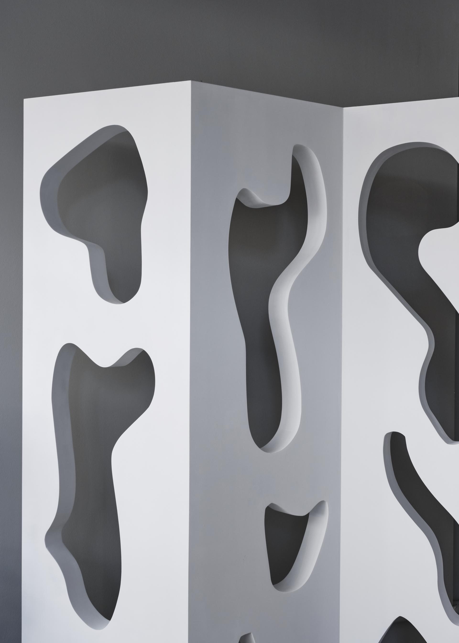 Sculptural white furniture piece with abstract cutouts, showcased at the London Design Festival by Modern Art Hire.
