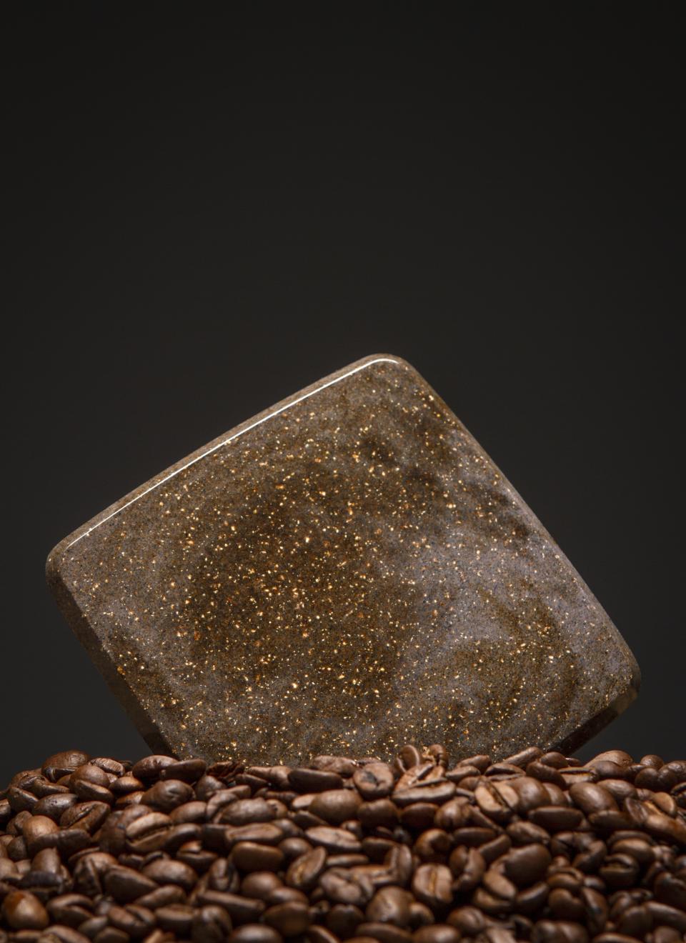 A lightweight granite-like material resembling That’s Caffeine, displayed atop roasted coffee beans.