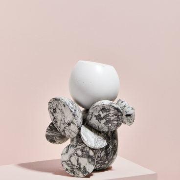 Unique ceramic vase featuring a white top and marbled black stones, showcasing contemporary design by Vic Wright.