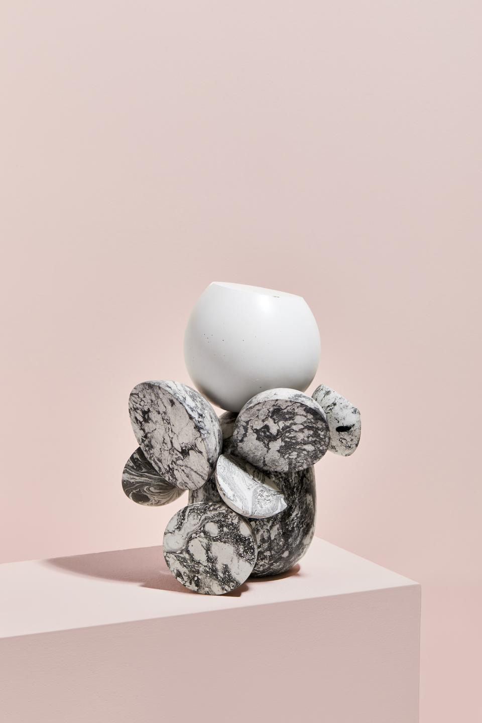 Unique ceramic vase featuring a white top and marbled black stones, showcasing contemporary design by Vic Wright.