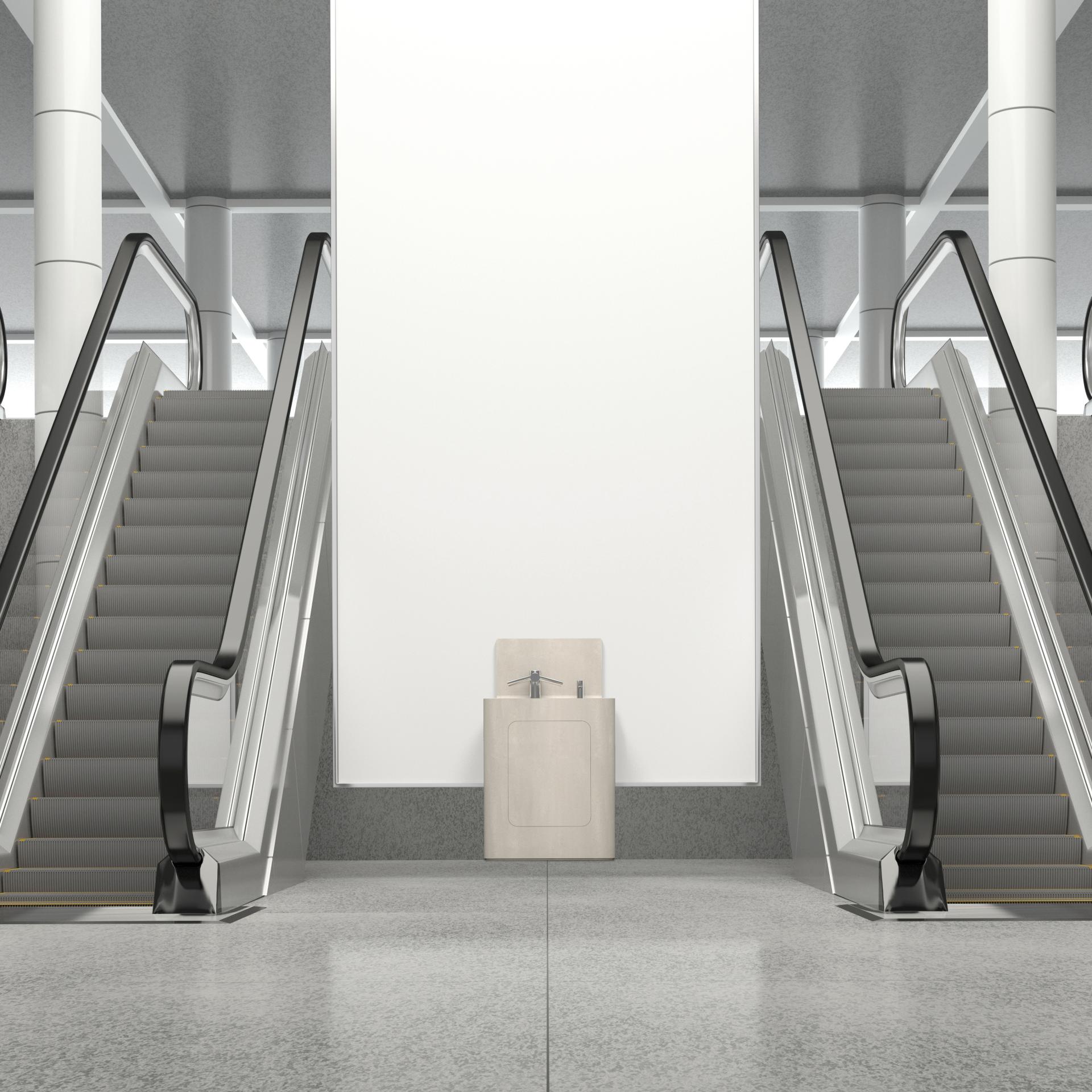 Hygienic Primo Specialist Washpod positioned between escalators in a modern public space, emphasizing cleanliness and accessibility.