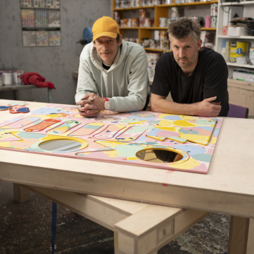 Collaborative artists working on colorful surface design project at Mirrl studio, showcasing vibrant patterns and craftsmanship.