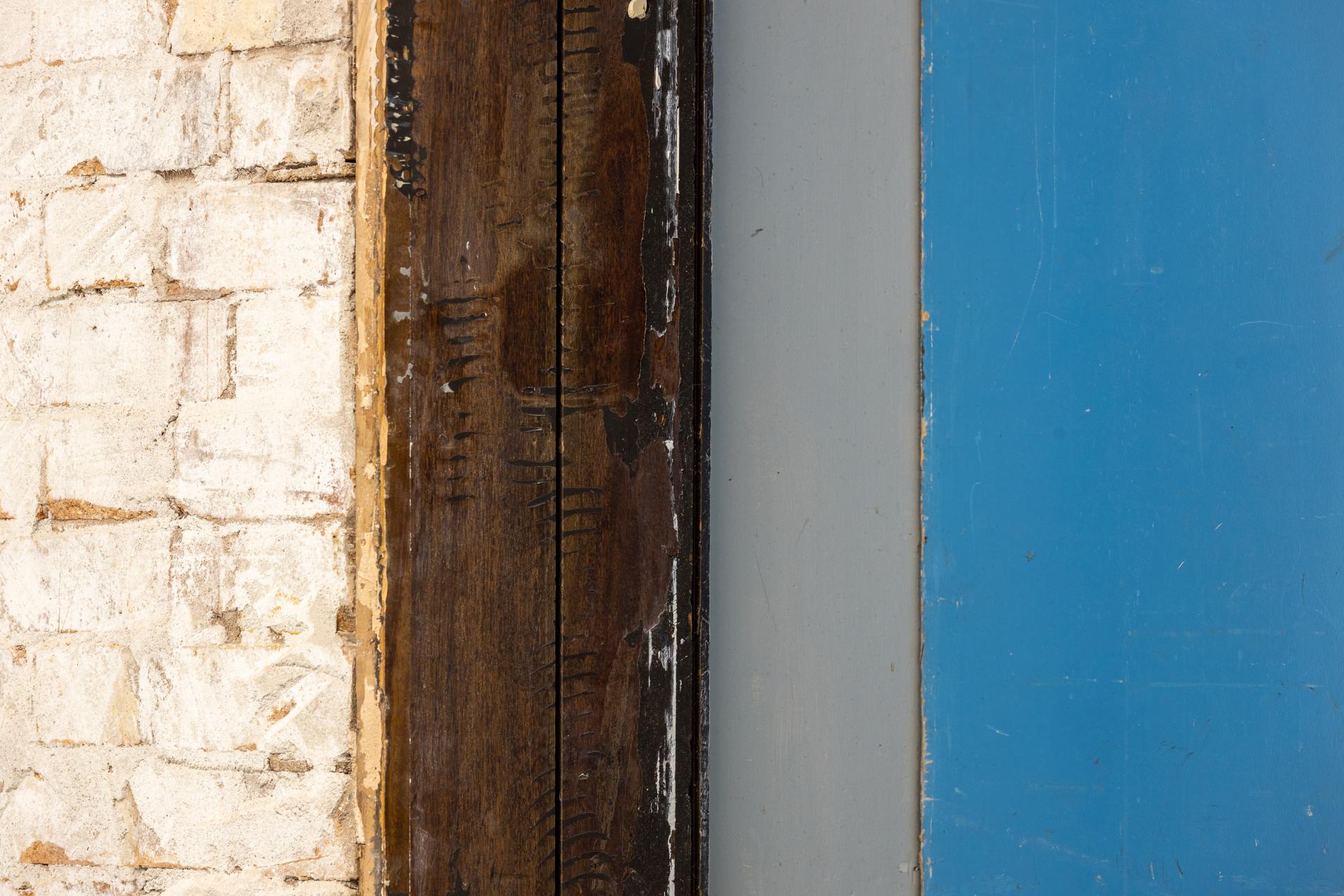 Textured wall segments including rustic wood and painted surfaces, embodying the unique character of the New Century venue.