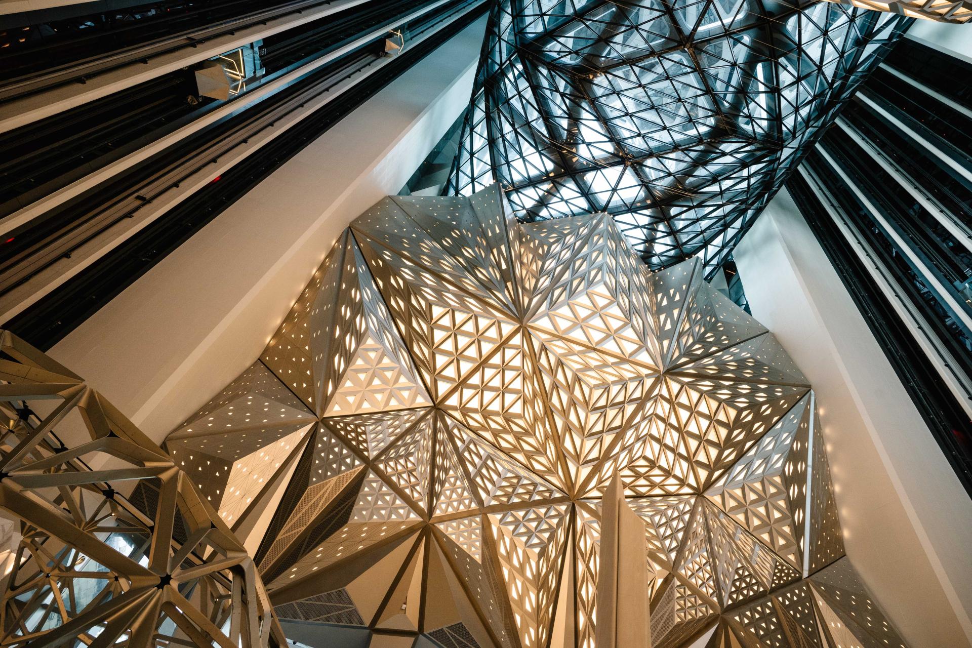 Innovative architectural design featuring a geometric ceiling illuminated by natural light at Maggie’s St Barts.