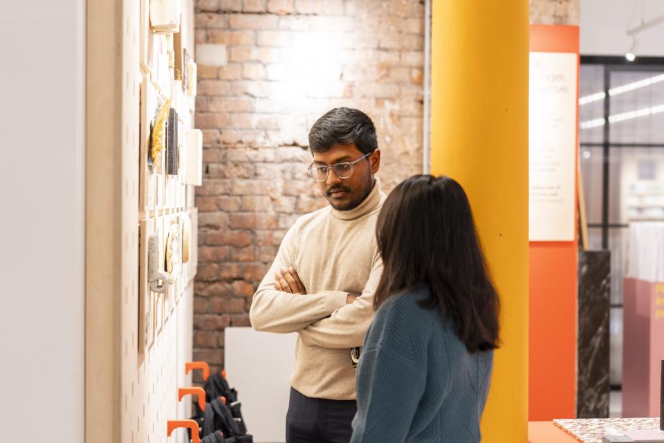 Visitors engaging with diverse art pieces at Material Source Studio during the Community 2024 celebration event in Manchester.
