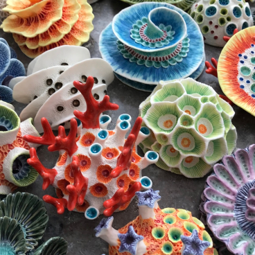 Colourful clay sculptures of coral reefs and sea life, showcasing intricate designs by Aardman Animations sculptor Lisa Stevens.