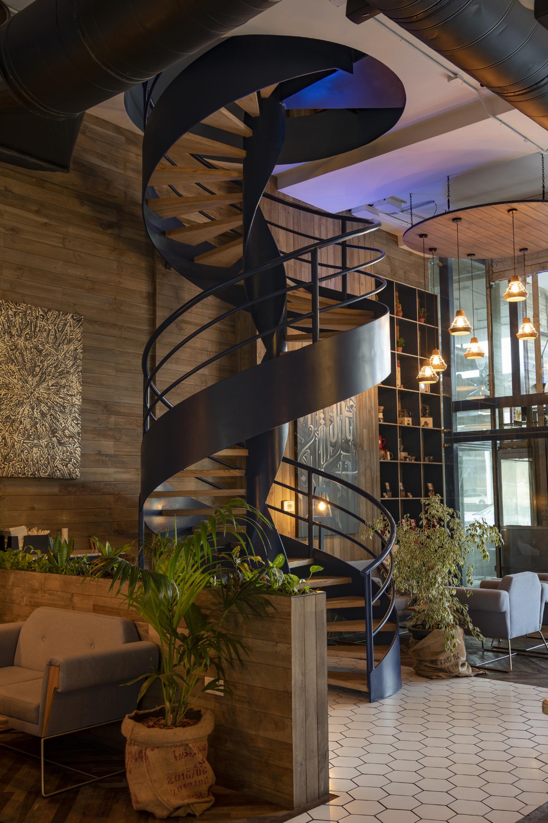 Spiral staircase in Brew92's interior, featuring warm wood accents and modern design elements in a specialty café setting.