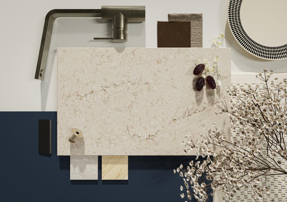 Taj Royale surface with warm beige tones, dark brown veins, and white accents alongside complementary materials and decor elements.