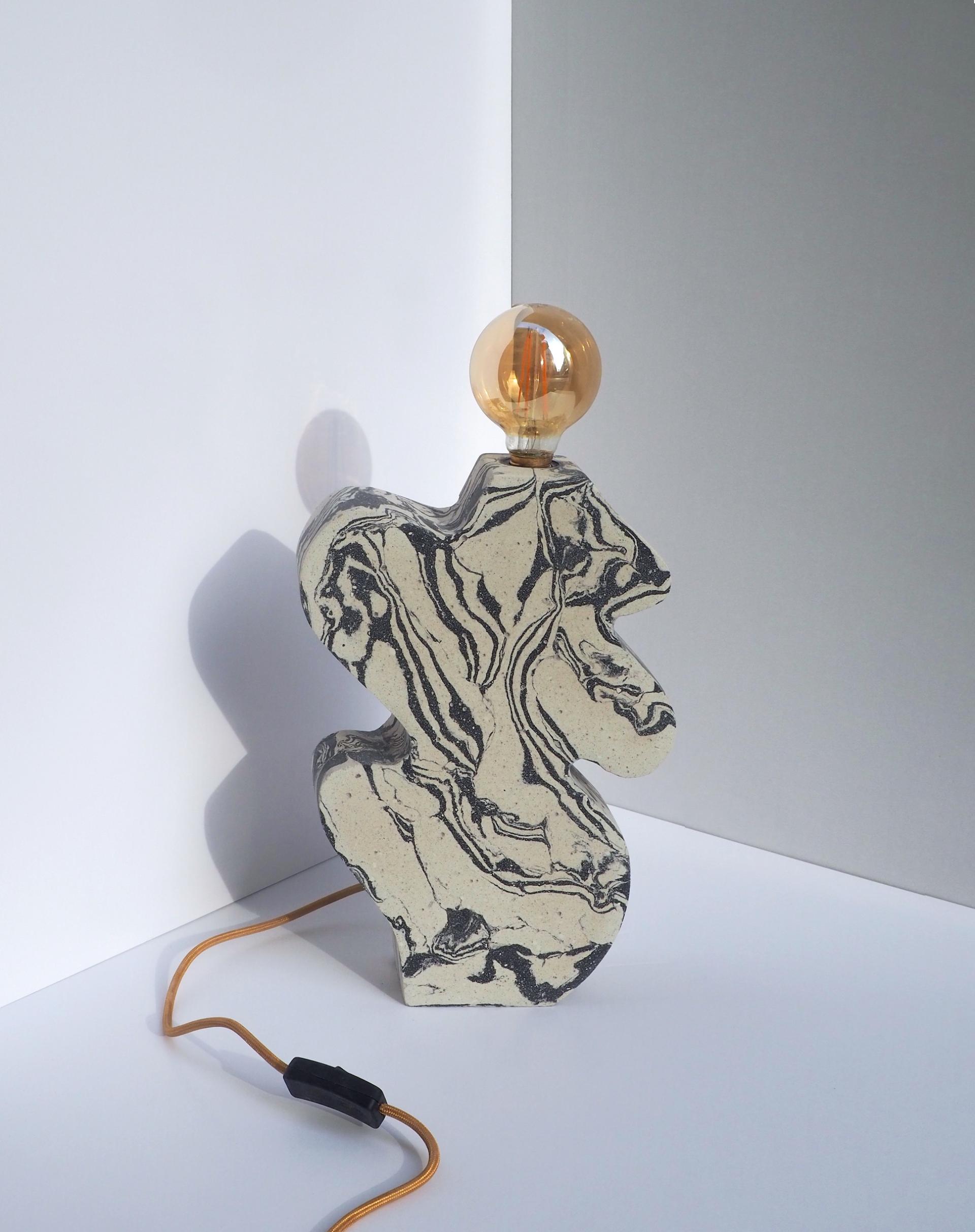 Unique concrete lamp from Tosco Studio showcasing artistic design and beauty in imperfections, enhancing modern decor aesthetics.