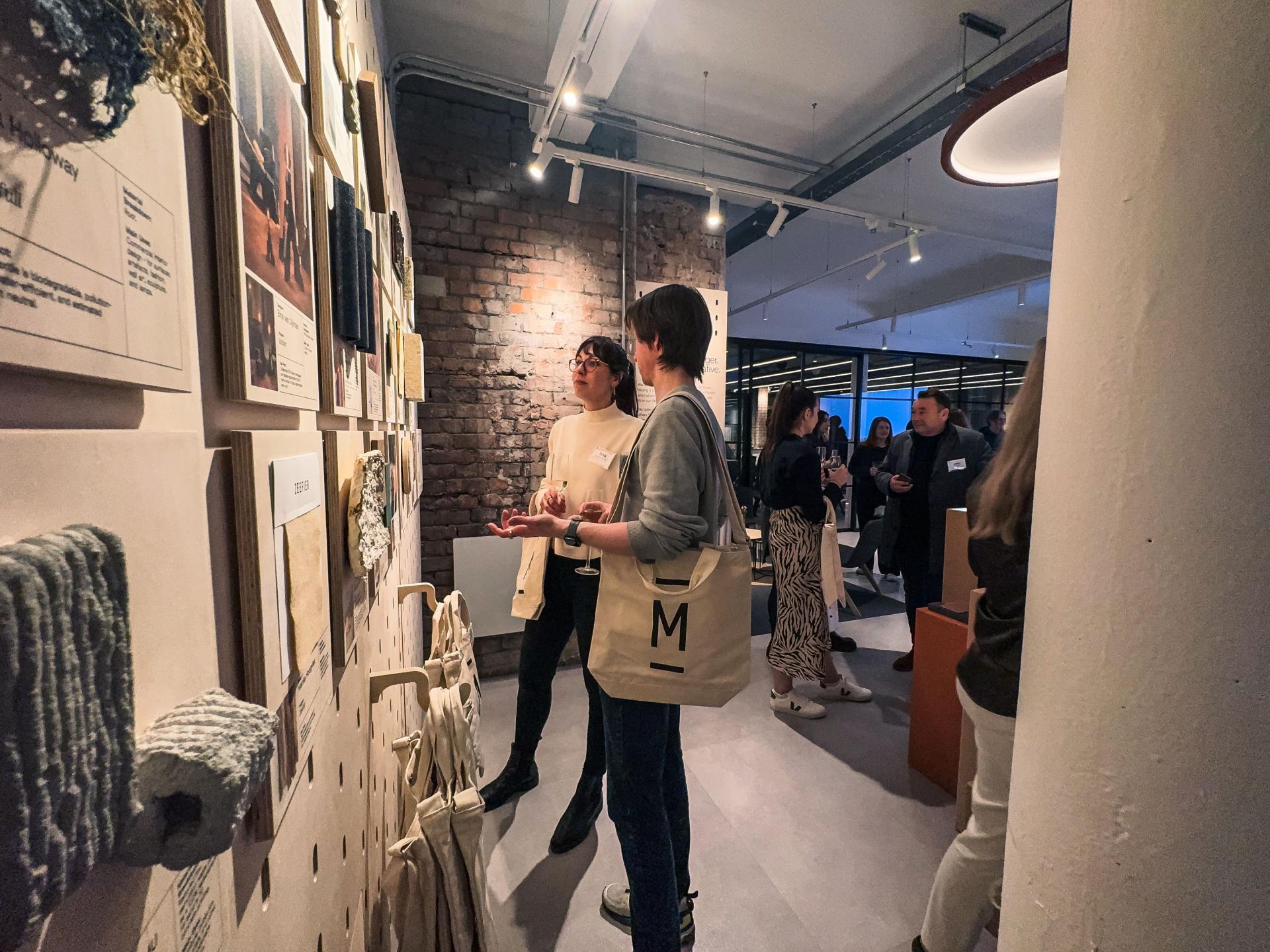Visitors engage with bio-based materials at the exhibition "This Is No Longer Speculative" at Material Source Studios.