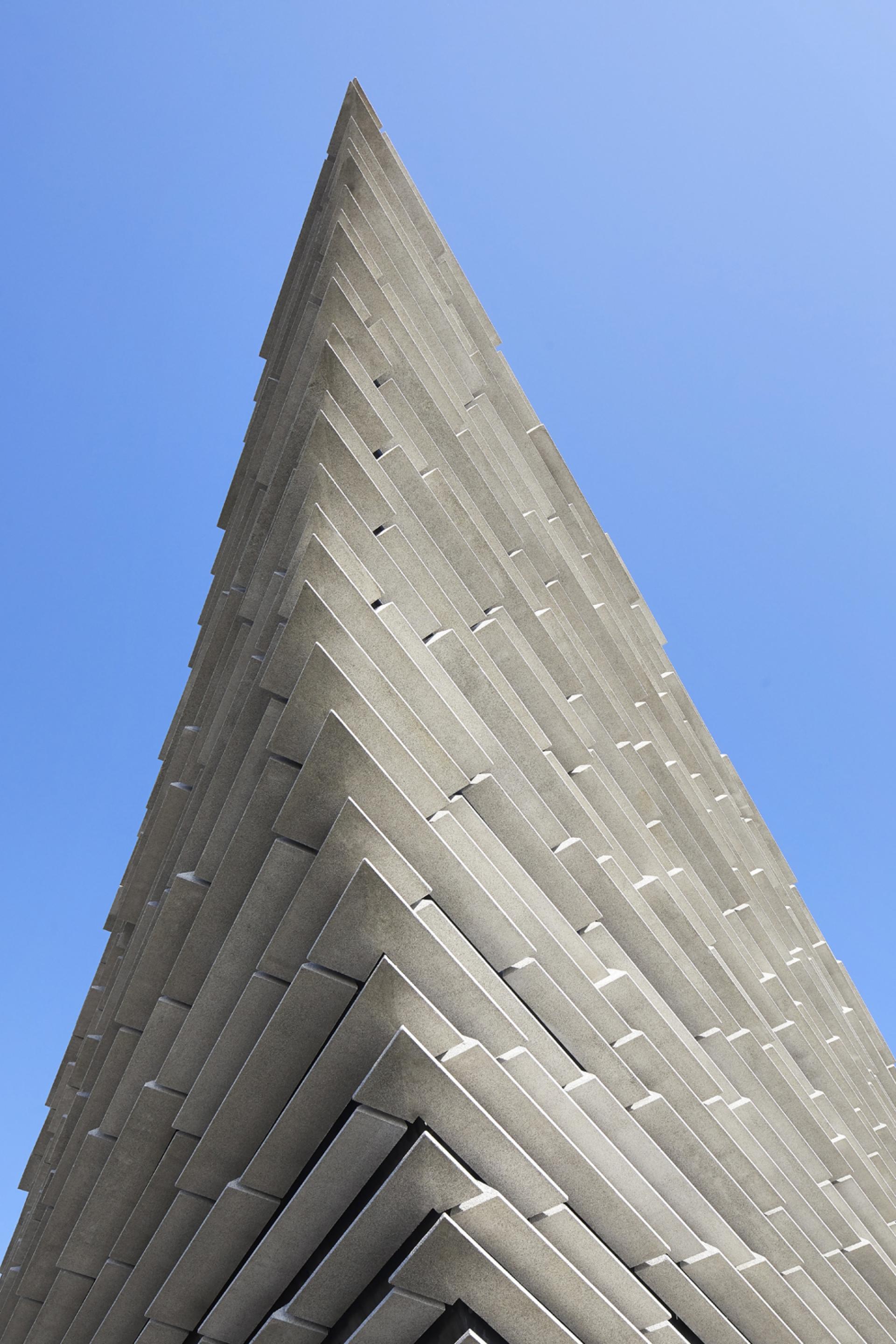 V&A Dundee's striking angular architecture designed by Kengo Kuma, showcasing its unique light-filled spaces against a clear sky.