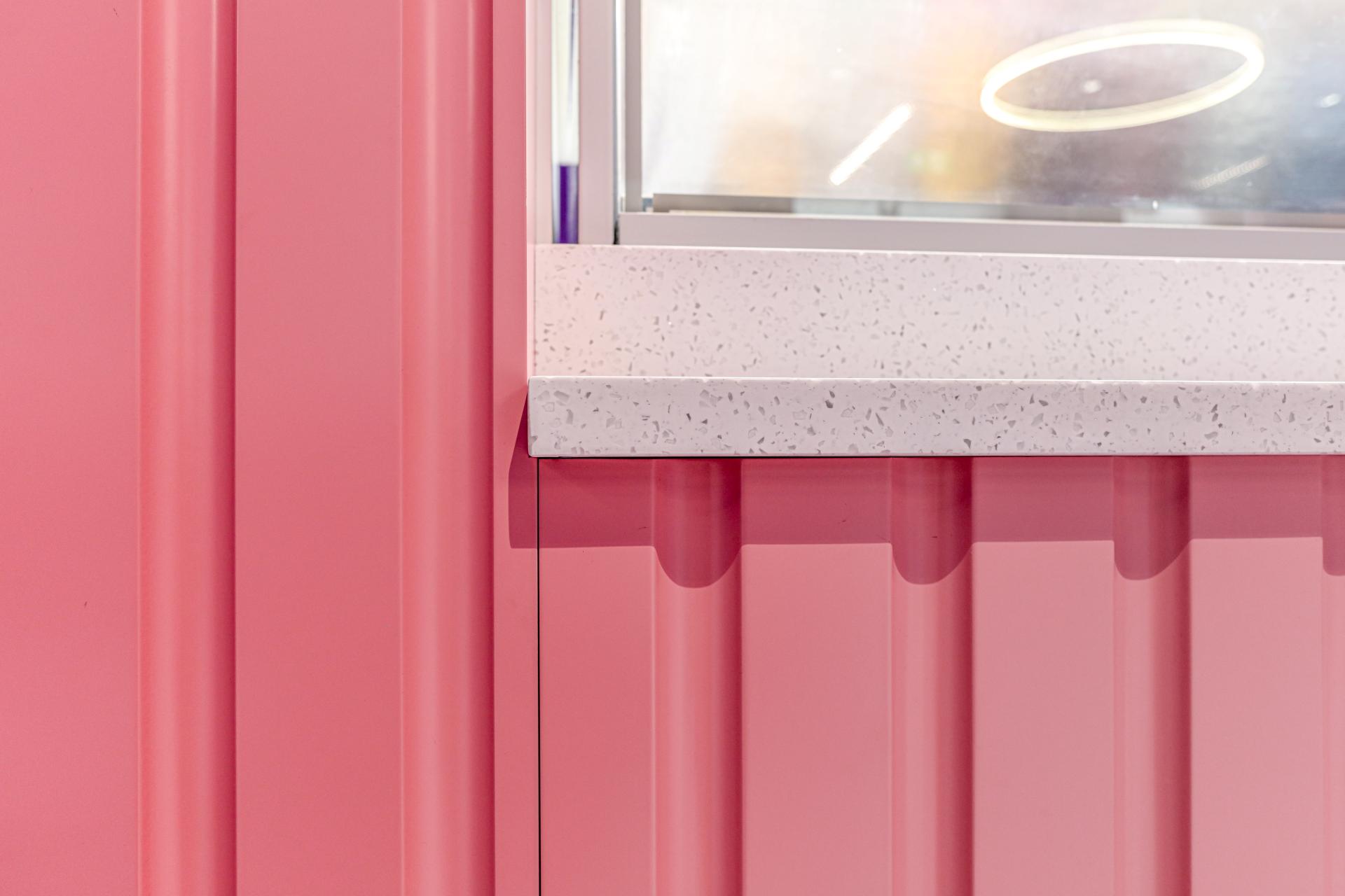 Colorful pink walls and a speckled white countertop create a whimsical atmosphere at Oh So Yum! in Bradford.