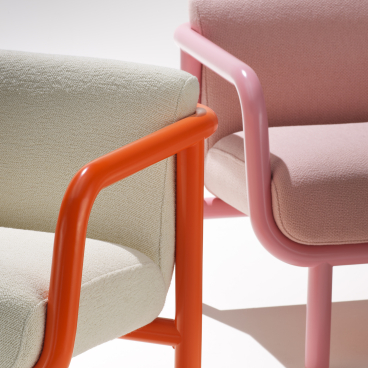 Bold Percy lounge chairs with colorful frames and textured upholstery, showcasing mid-century design inspiration from NaughtOne.