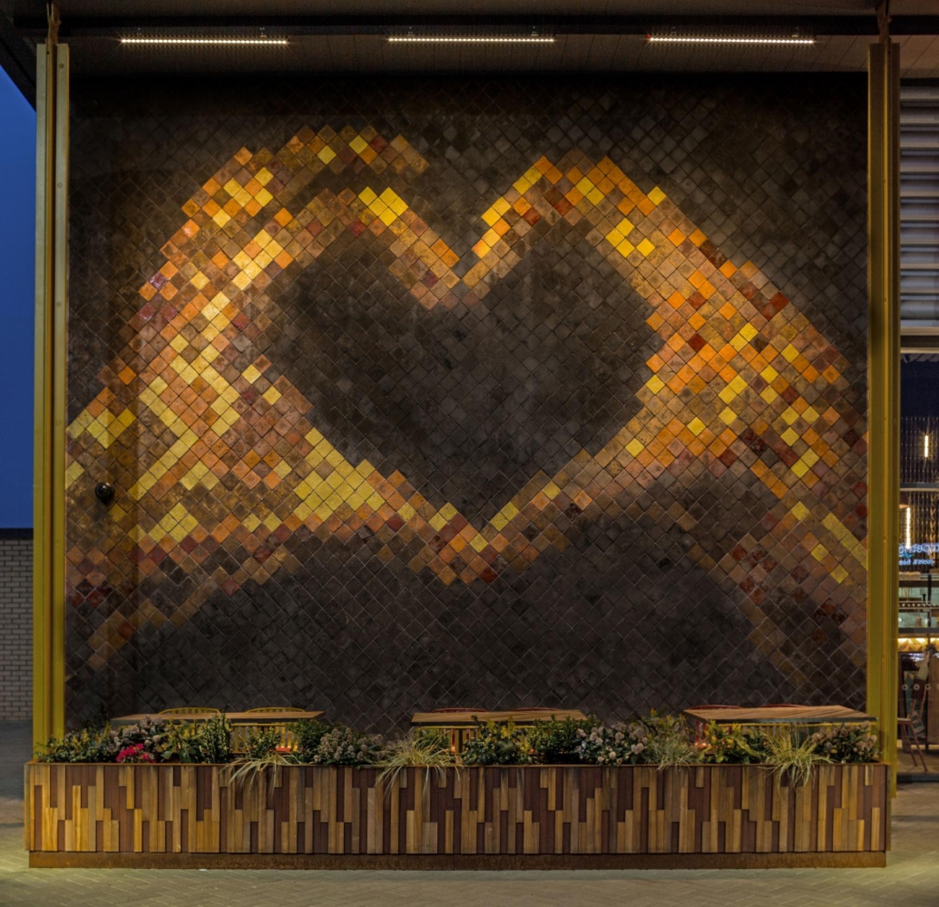 Colorful tiled mural in the shape of a heart, showcasing Casa Ceramica's innovative design approach and trendsetting style.