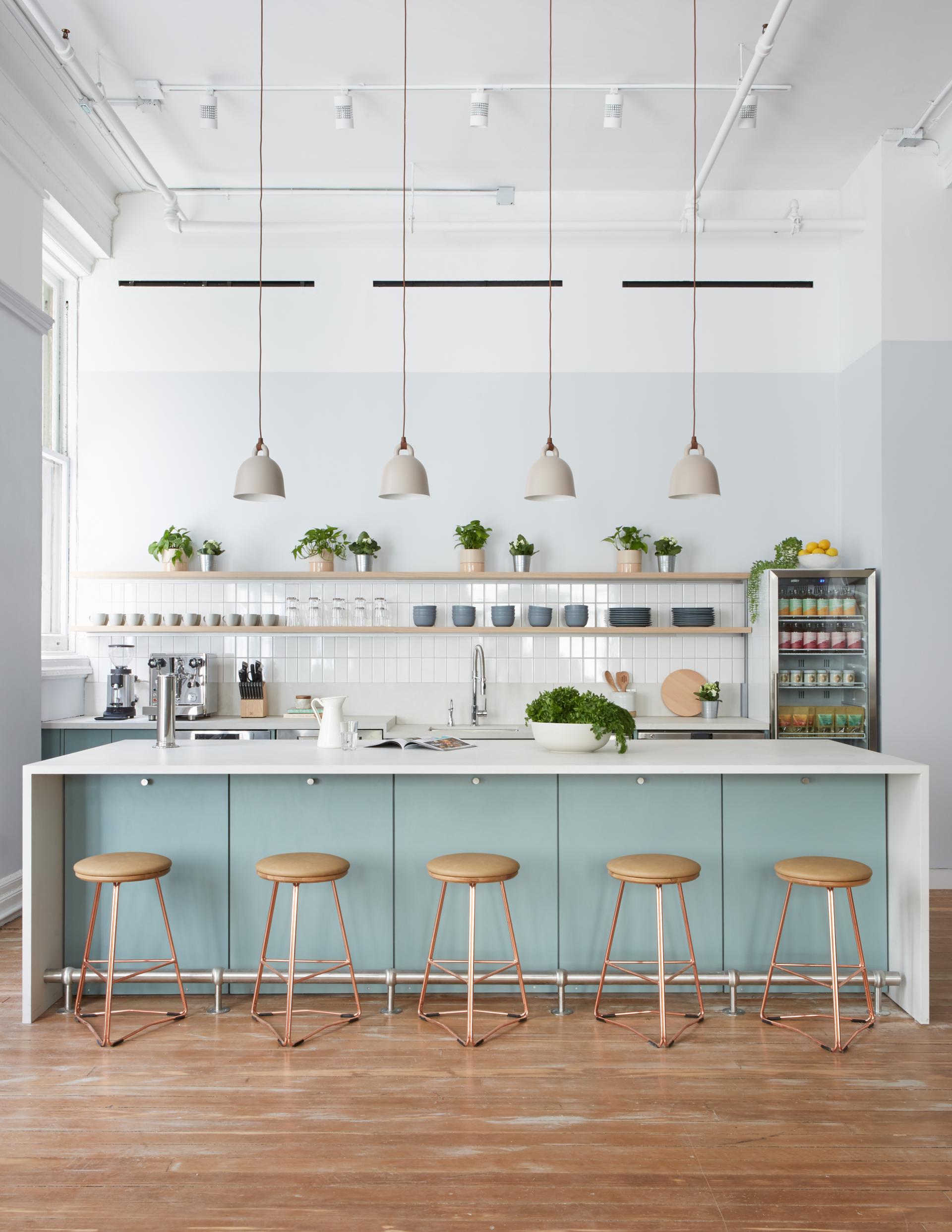 Modern kitchen featuring natural elements, with plants, light-colored cabinetry, and stylish pendant lighting, reflecting Alda Ly Architecture's design philosophy.