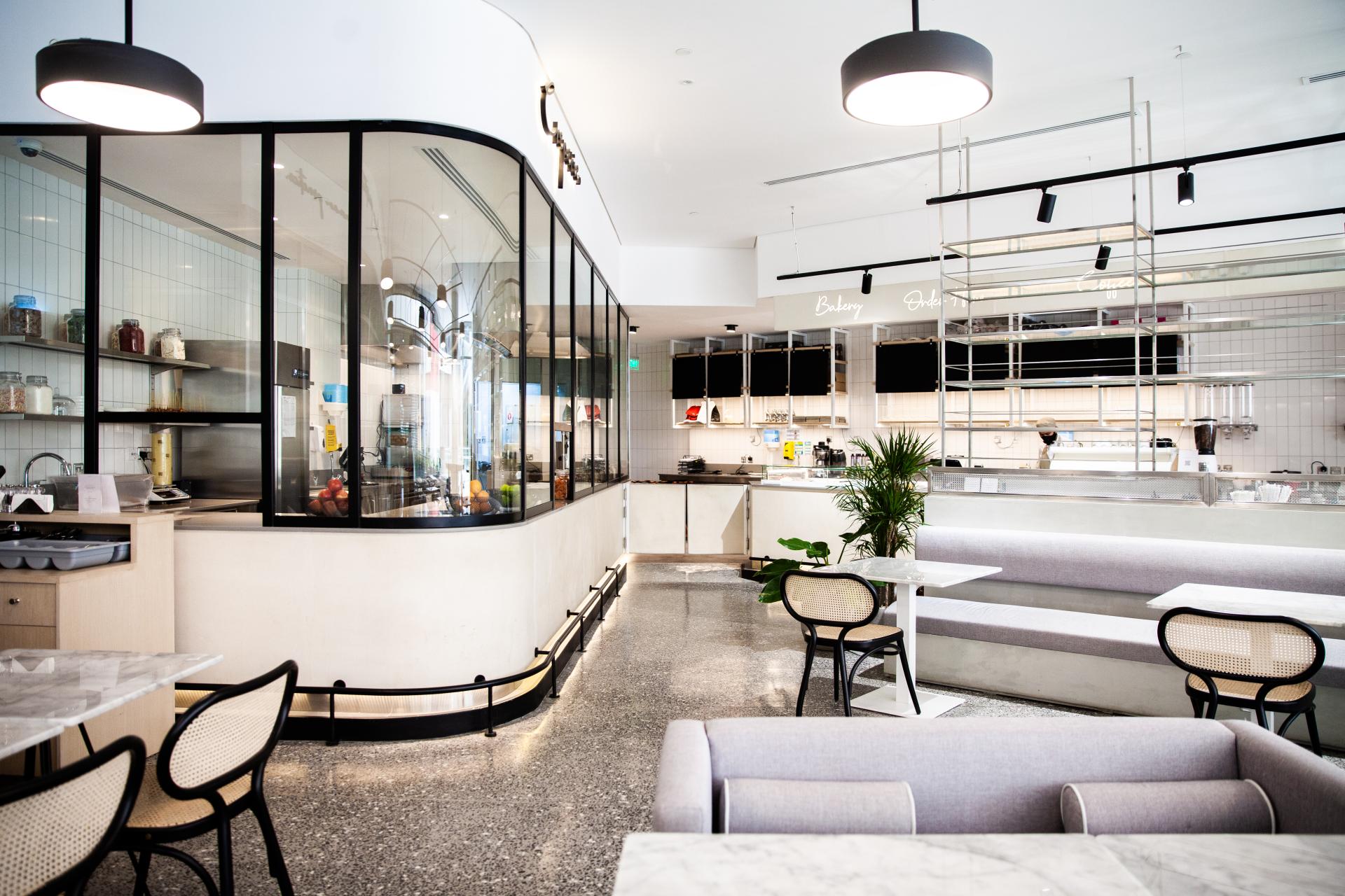 Modern interior of Chunk bakery in Riyadh, featuring stylish seating, open kitchen, and display of fresh pastries and desserts.