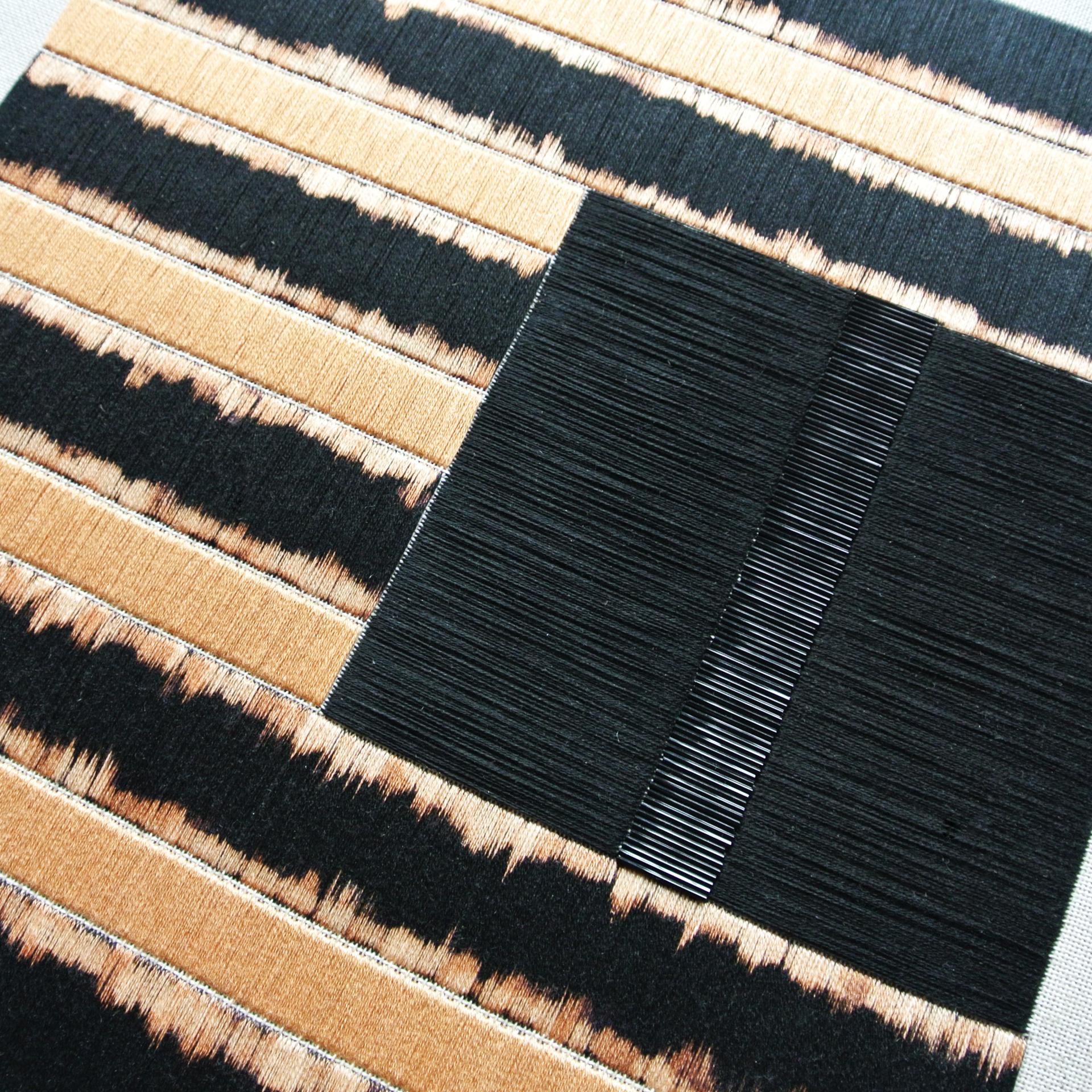 Intricately designed contemporary wall hanging featuring traditional Slovakian embroidery techniques with bold black and tan colors.