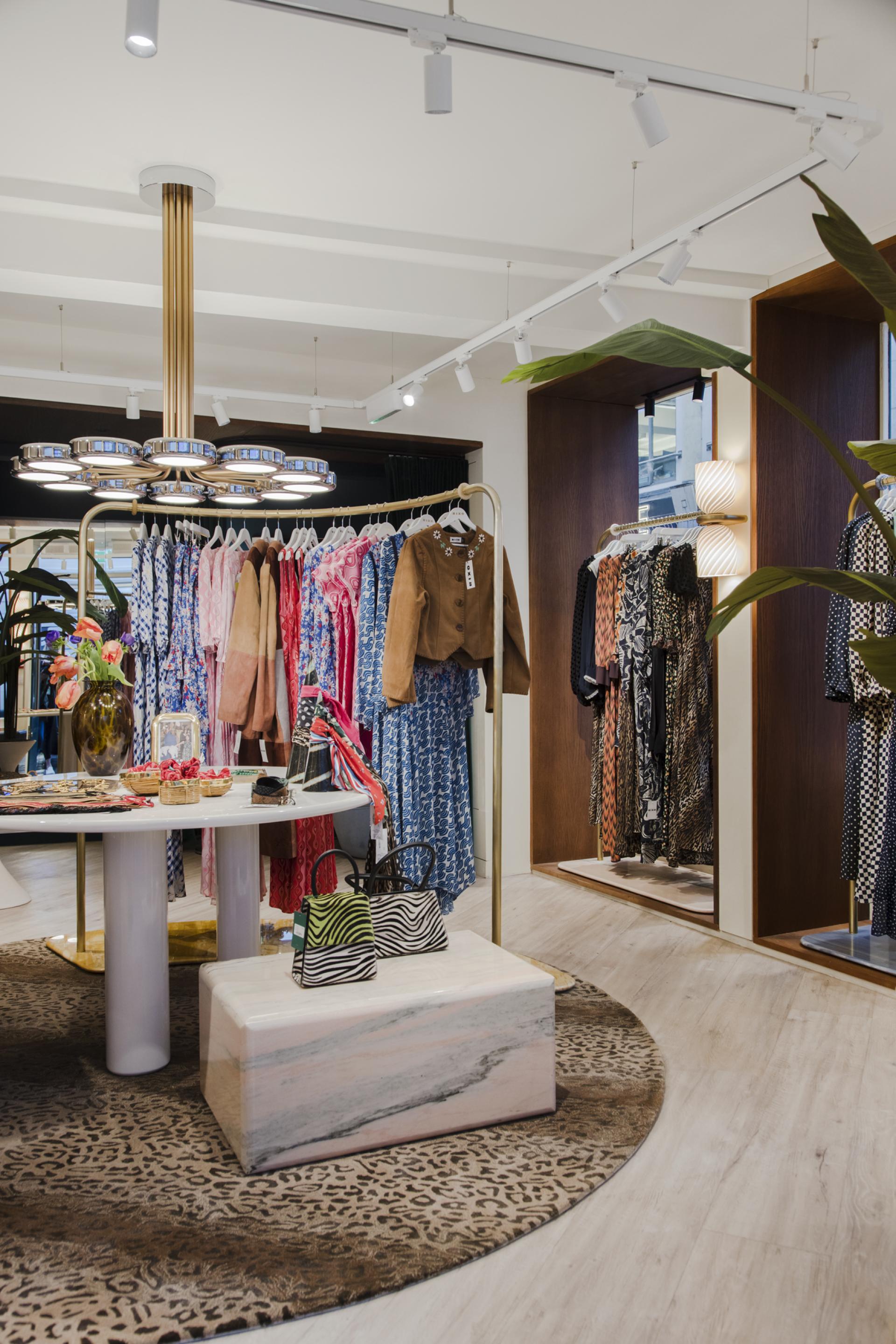 Rixo's Carnaby store features a stylish interior with vibrant dresses, modern lighting, and Karndean Pearl Oak flooring.