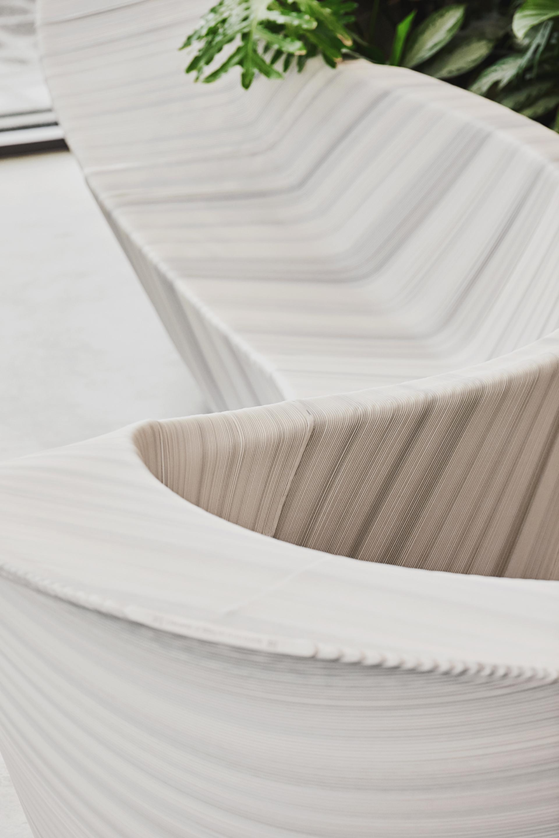 Multifunctional entrance furniture, Stratum, designed by The New Raw, featuring a unique, textured surface and elegant curves.