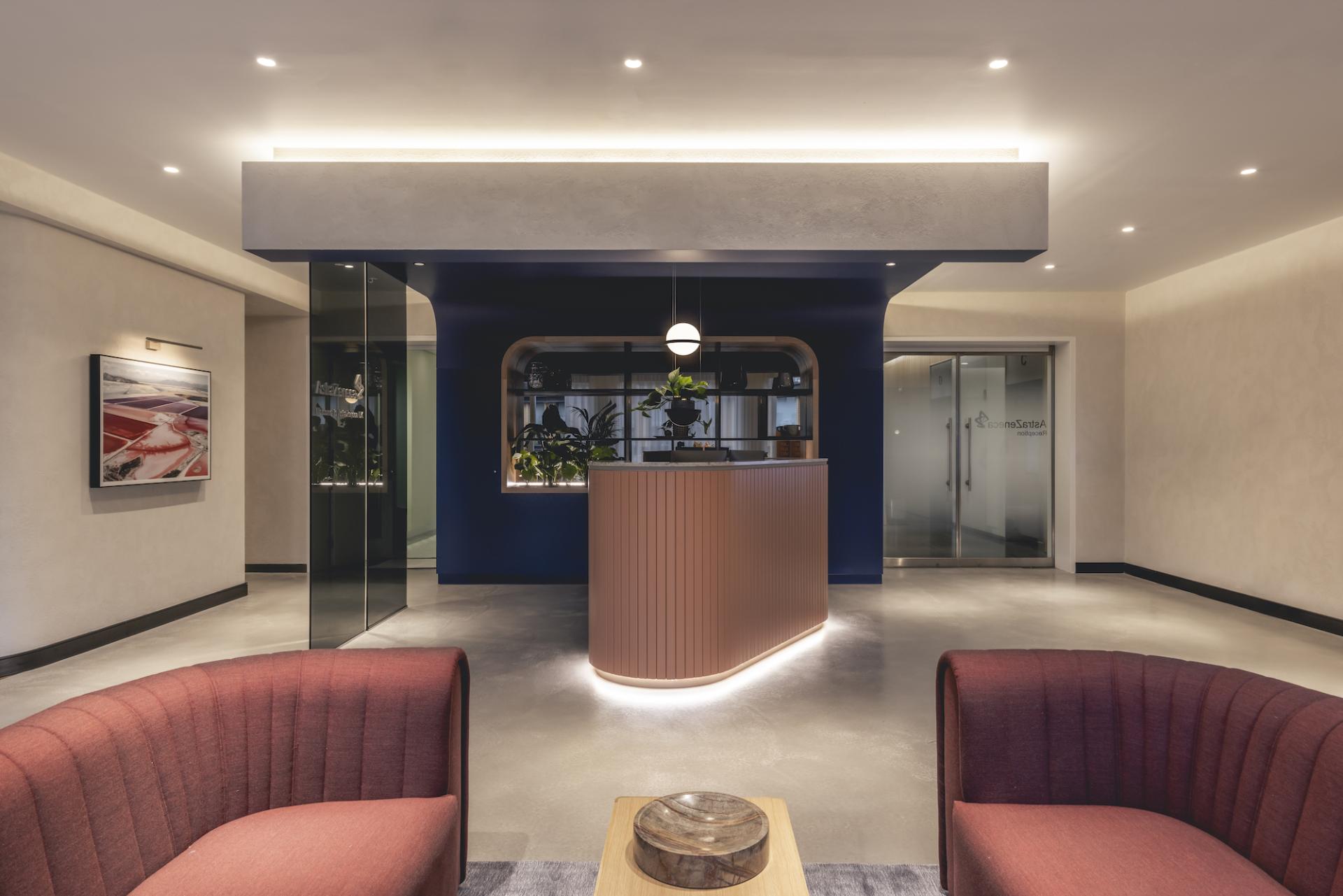 Modern reception area of AstraZeneca UK's office, showcasing stylish furniture and innovative design by Ekho Studio.