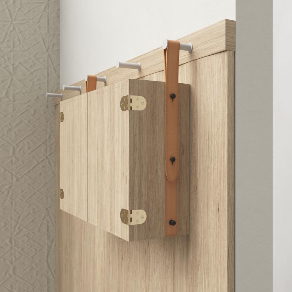 Stylish wooden cabinet with leather strap accent, showcasing Mutina's collaboration with OEO Studio for ceramic design.